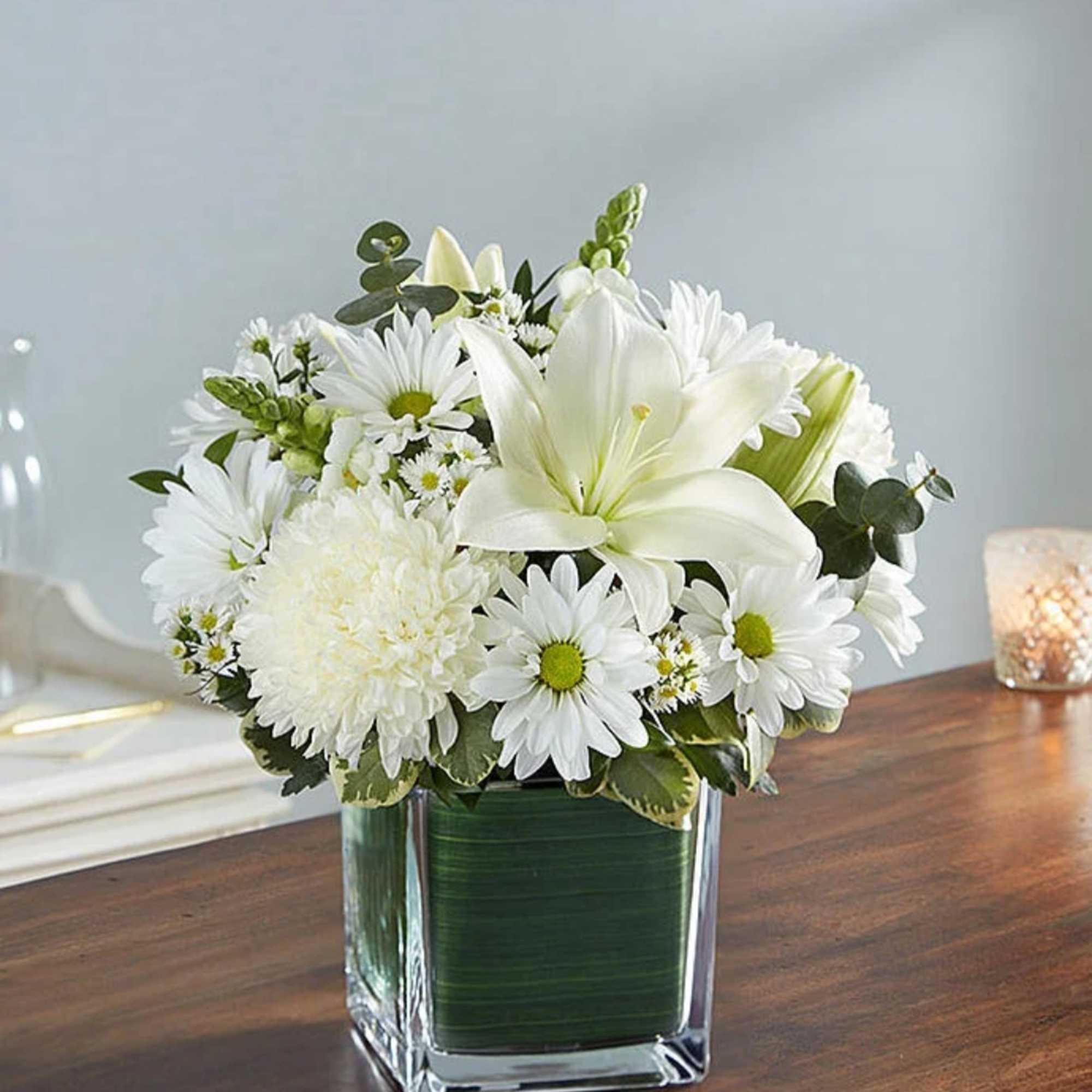 White flowers arranged in a square glass vase