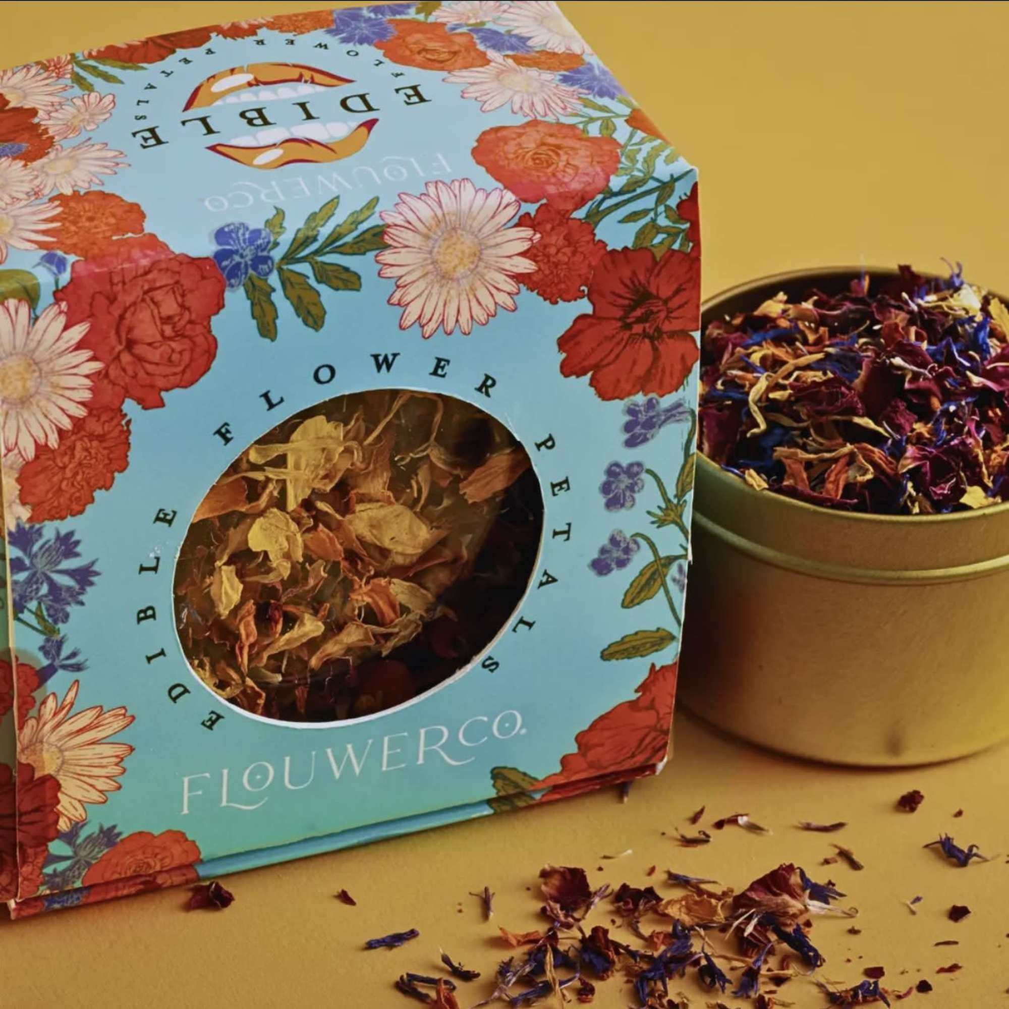 Box of dried flower petals beside a tin of loose petals