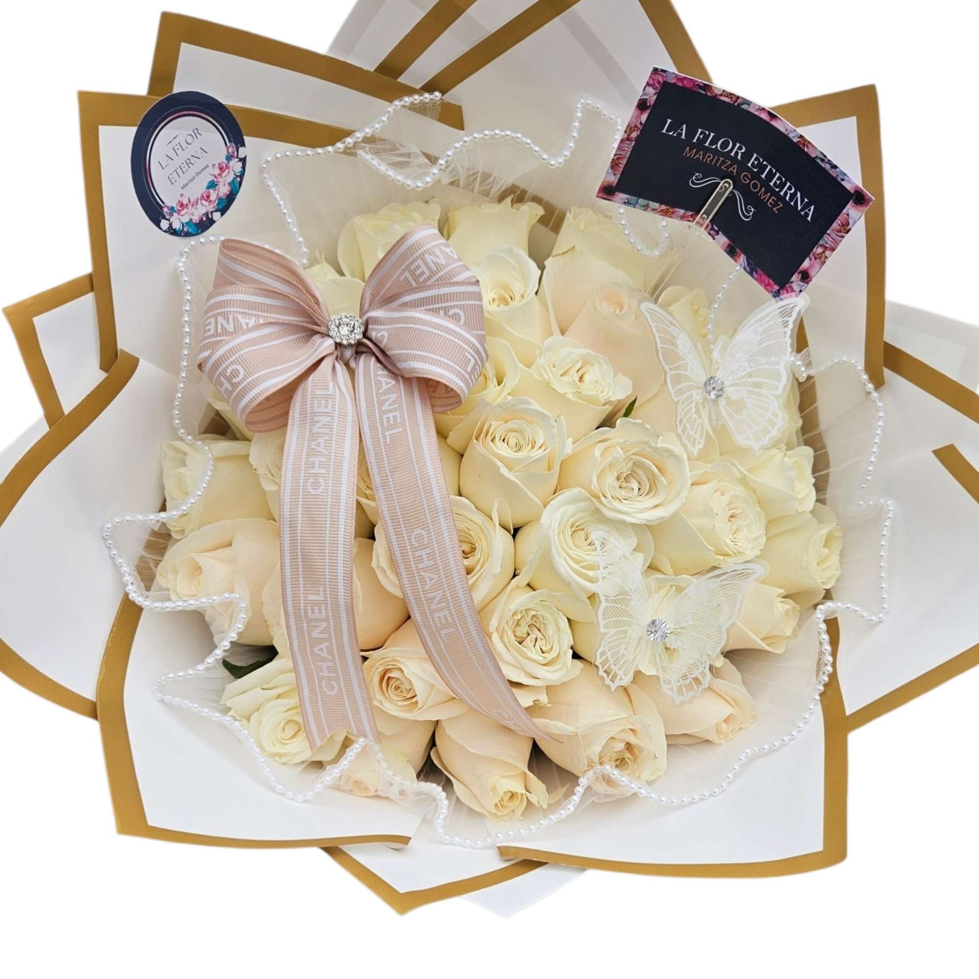 White  roses are tightly gathered into a classic rounded hand-tied bouquet