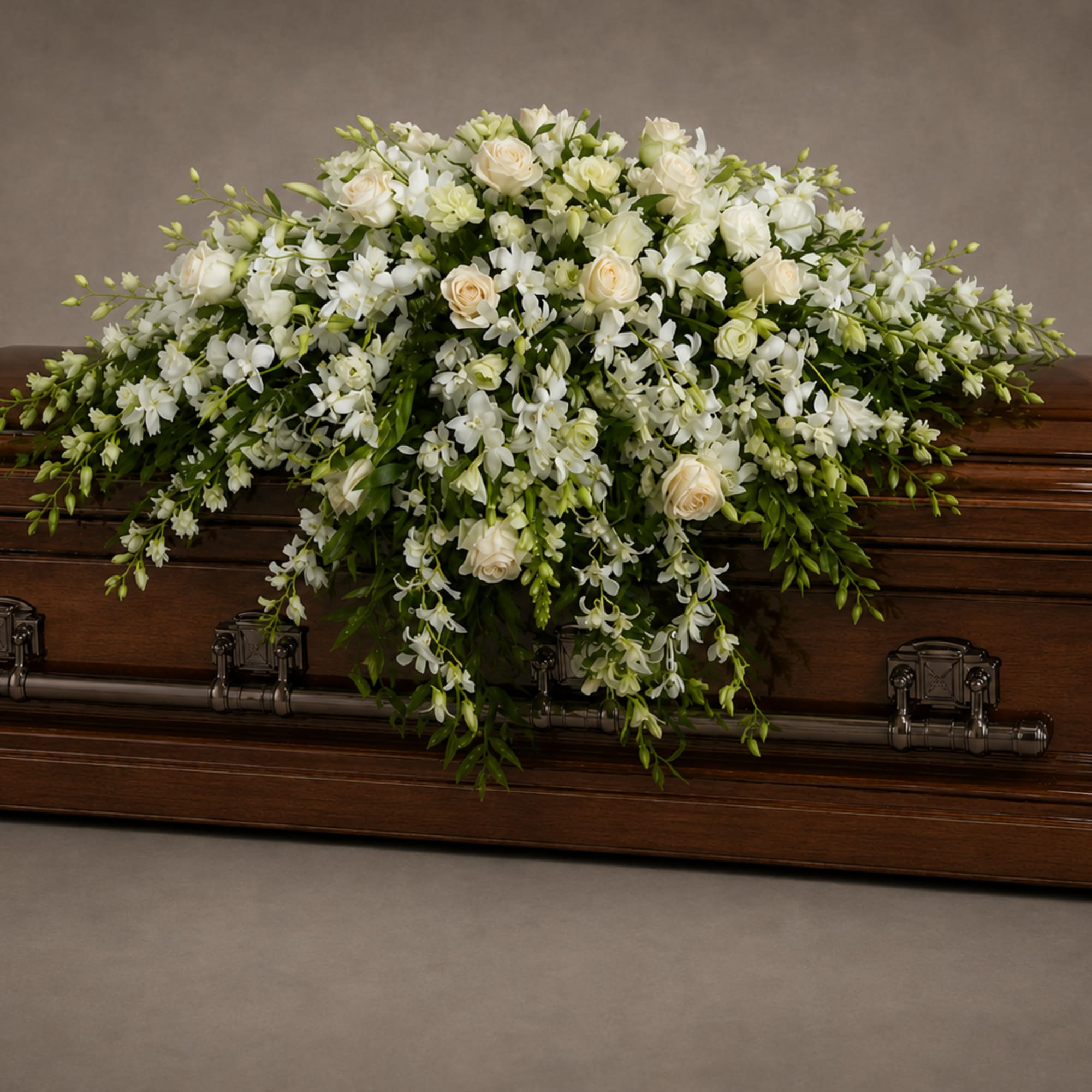 A serene cascade of cream and white roses, white lilies, and delicate