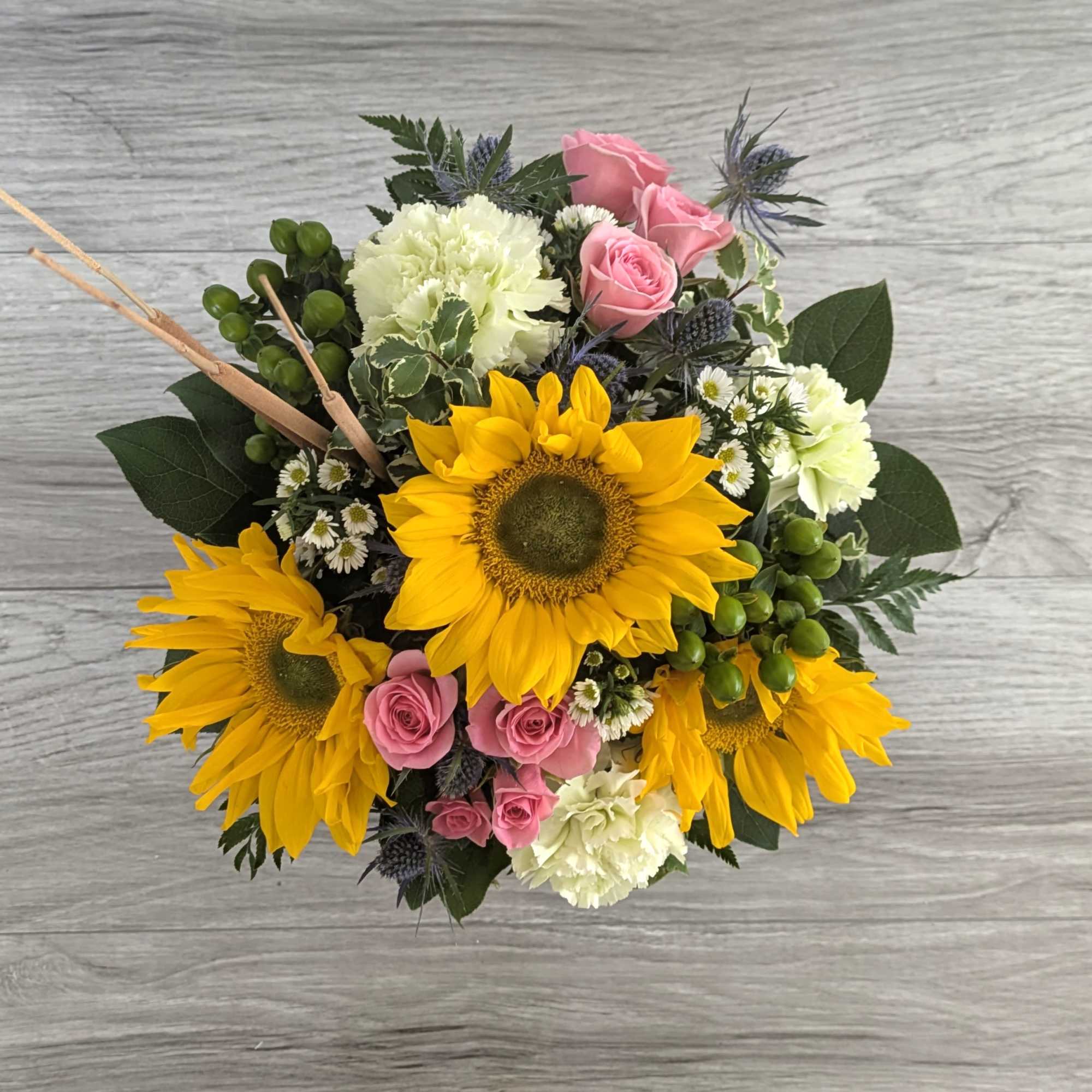 Bouquet with sunflowers, pink roses, and white carnations