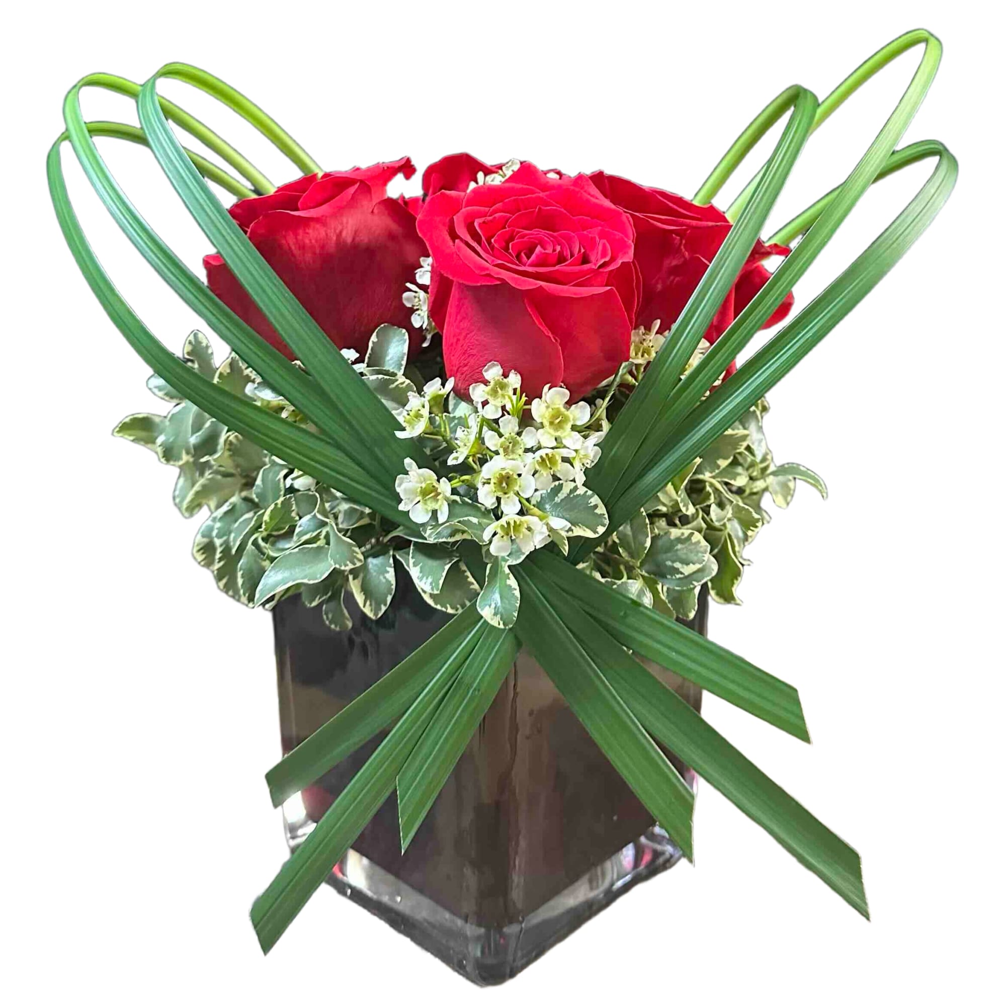 Fun, modern arrangement of roses with lily grass, waxflower and greens