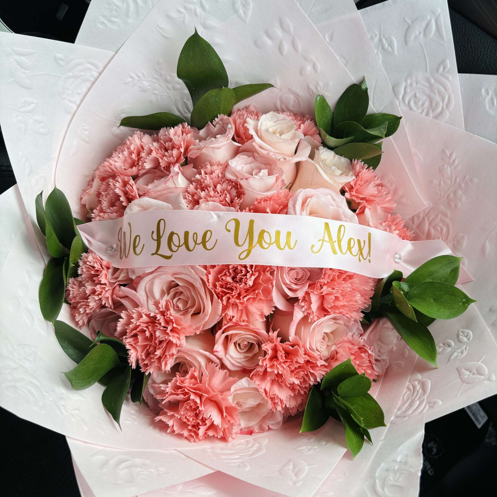 Pink rose and carnation bouquet with a "We Love You Alex!" ribbon