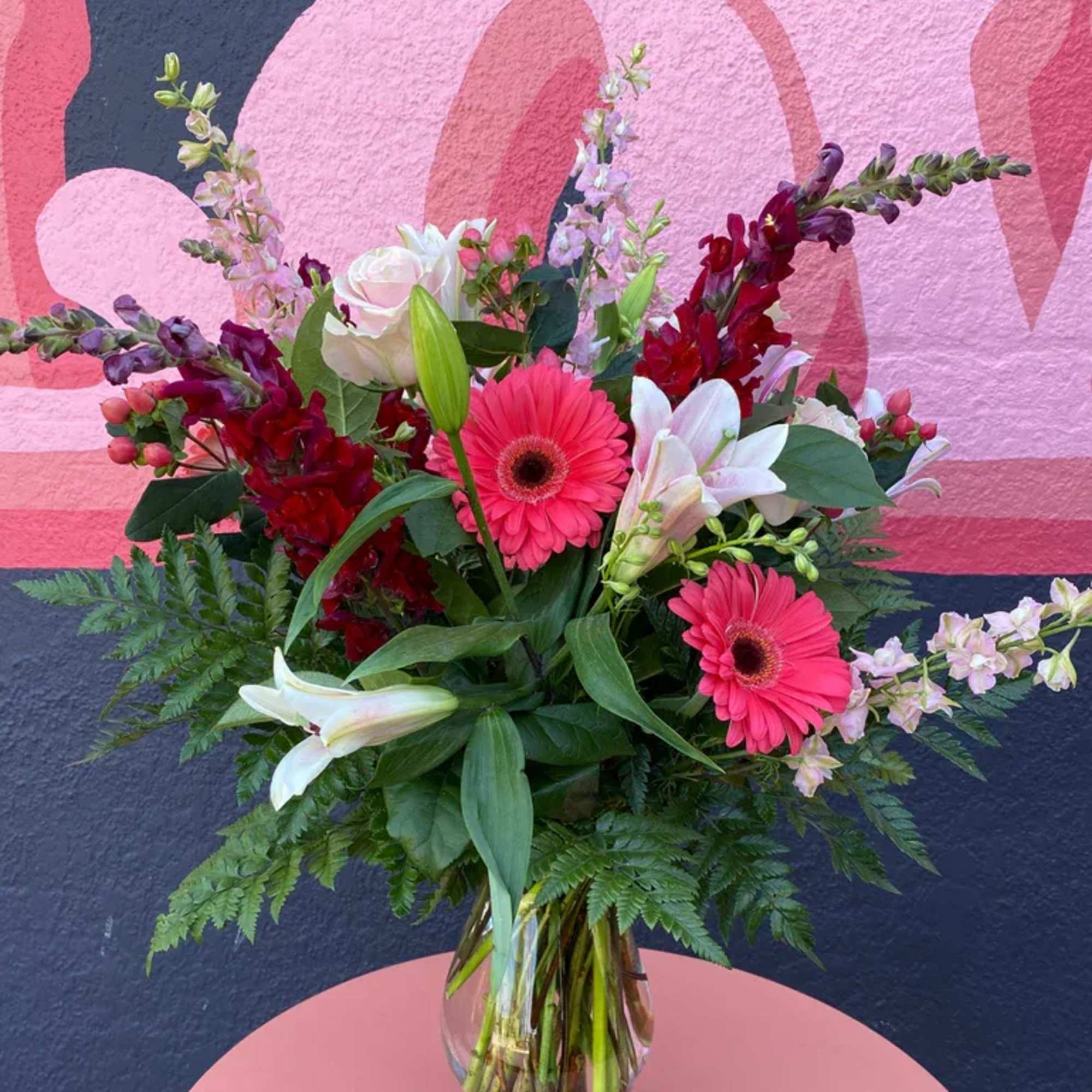 Pink and white mixed bouquet in a clear glass vase