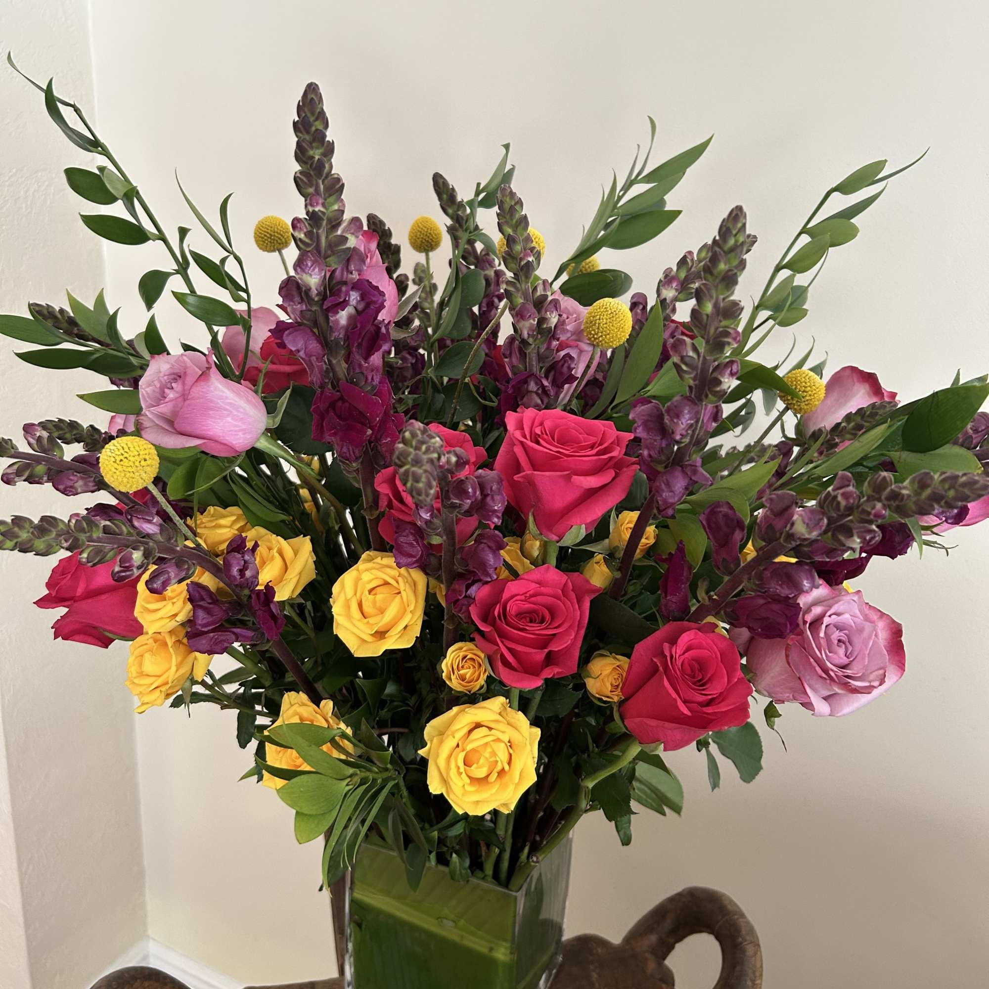 Mix of lively colored 2 dozen roses and various pom pom colors