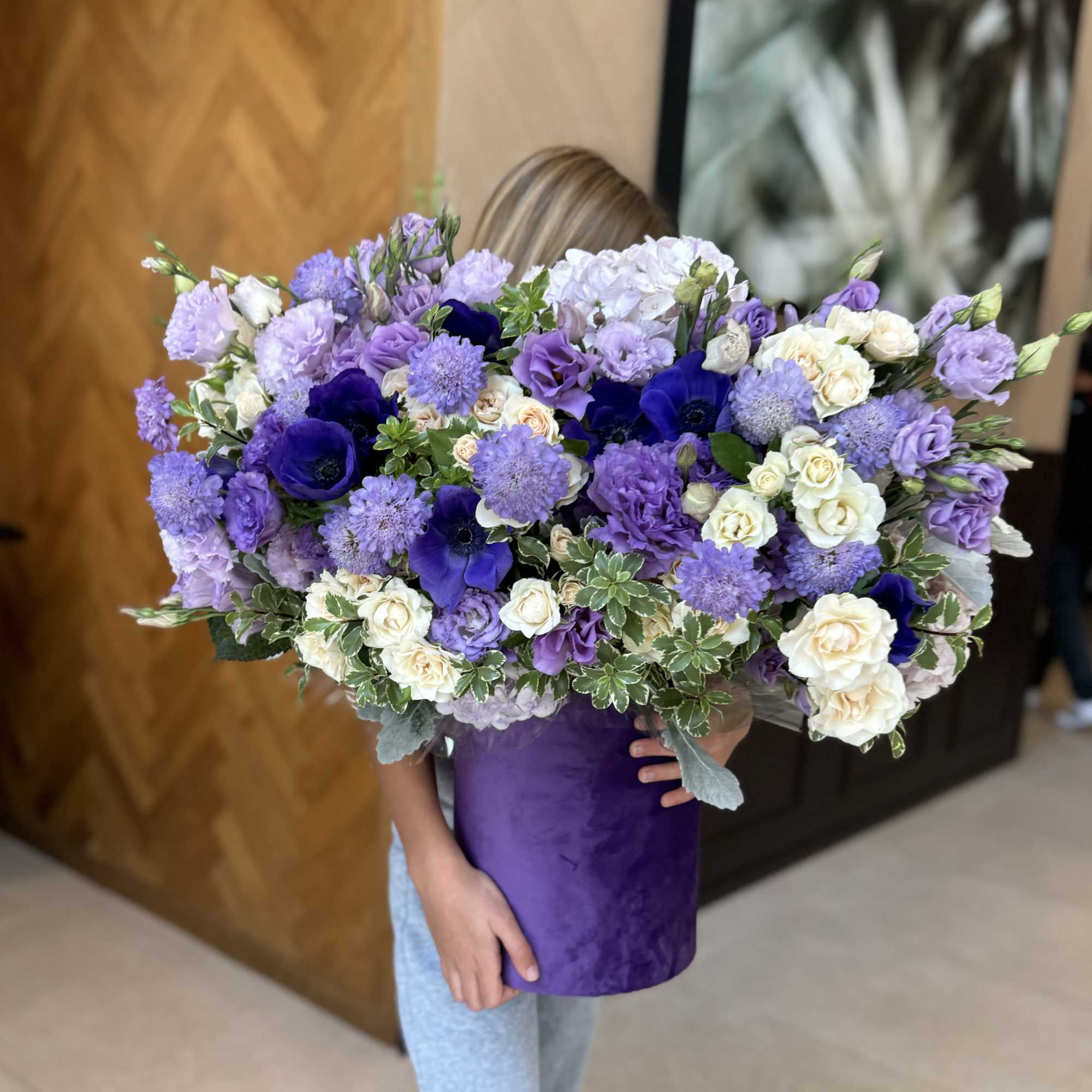 Large purple and white bouquet in a velvet hatbox
