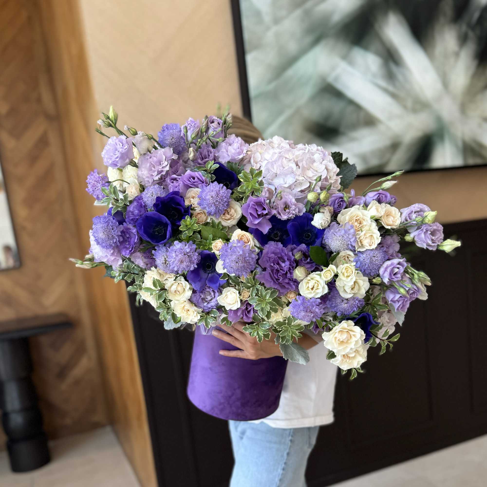 Large bouquet of purple and white flowers in a purple wrap