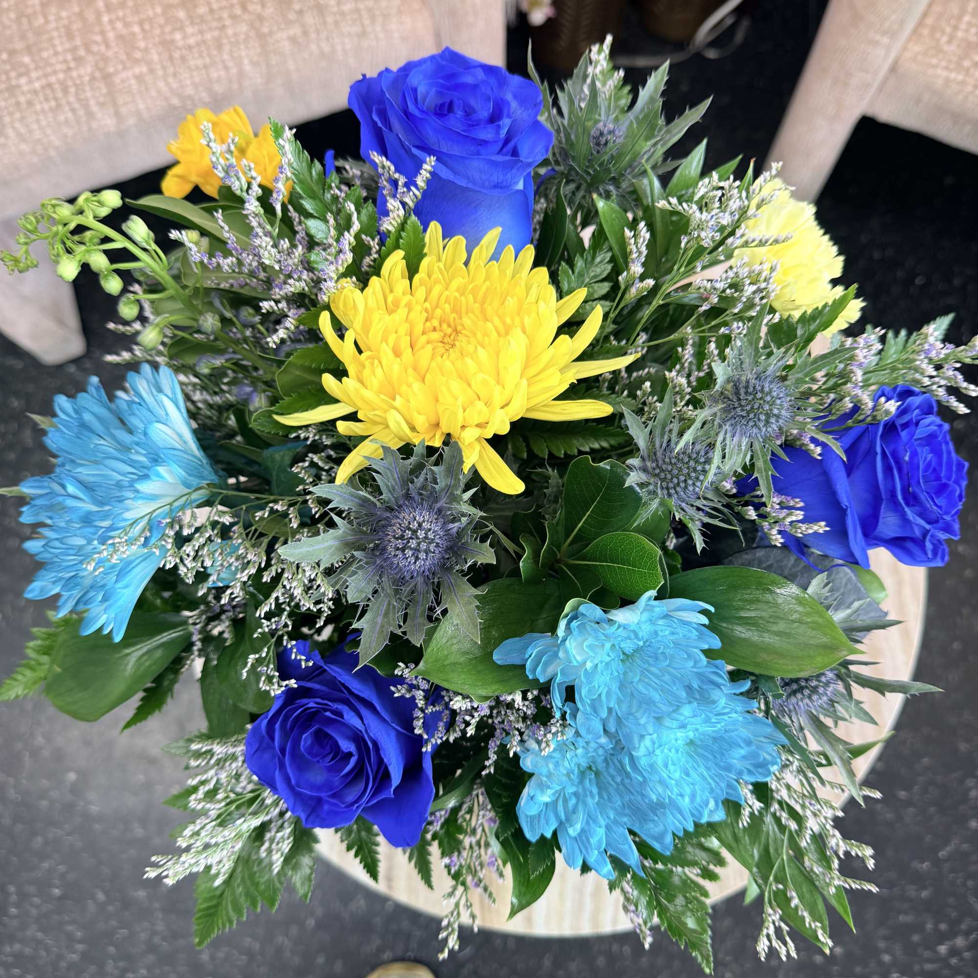Vivid cobalt-blue roses and bright blue chrysanthemums make a bold first impression