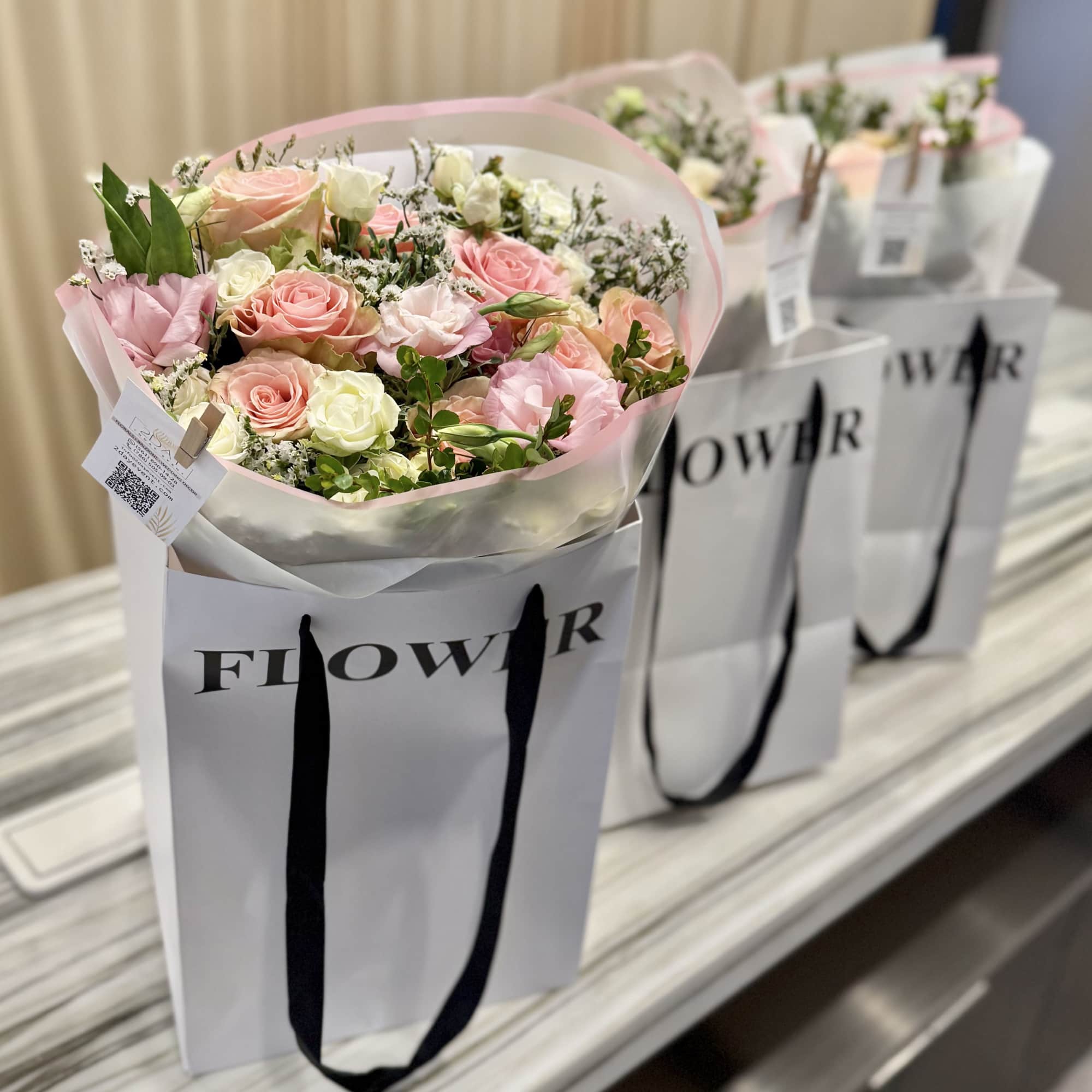 A soft, romantic hand-tied bouquet in blush pinks and creamy whites&mdash;the Hallandale