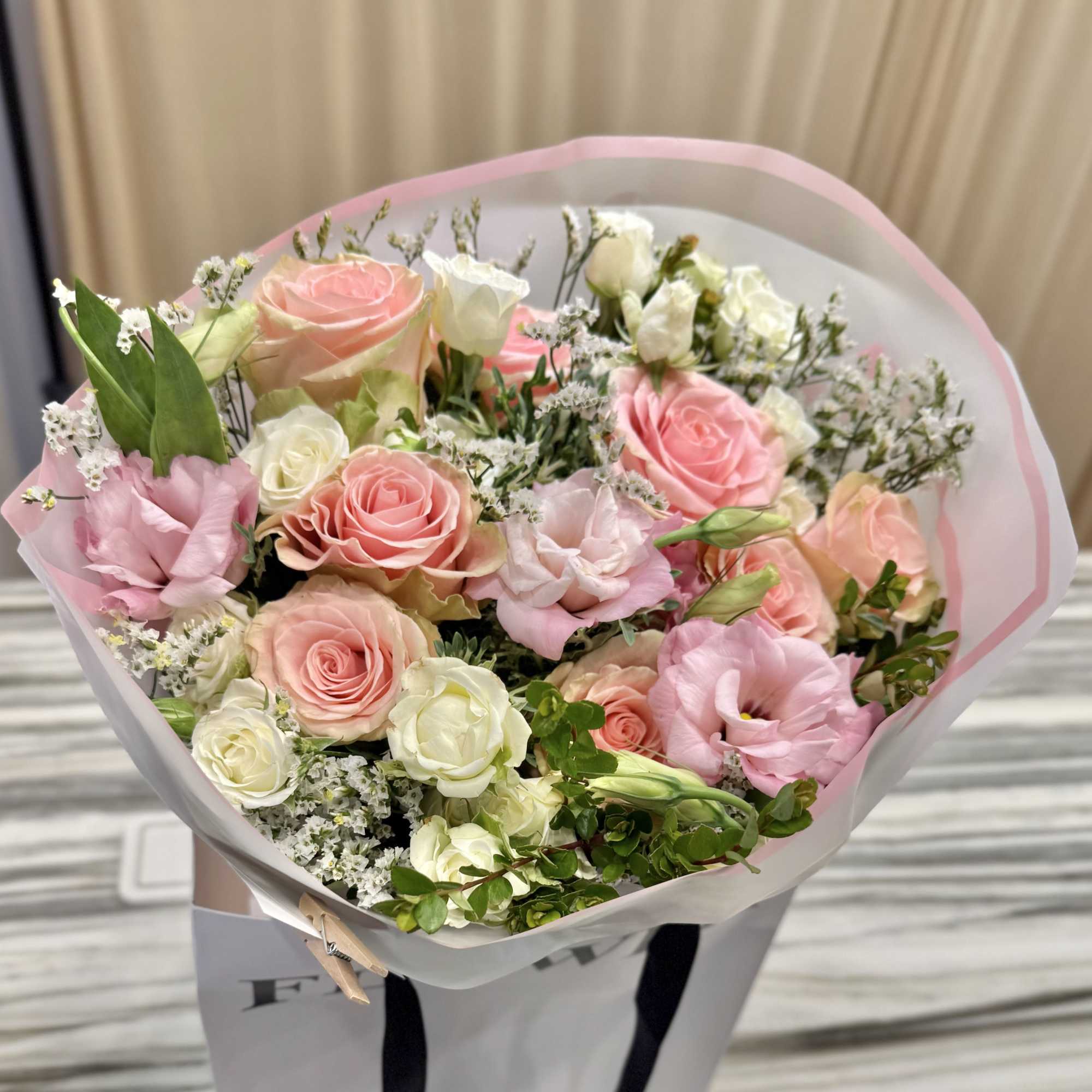 A soft, romantic hand-tied bouquet in blush pinks and creamy whites&mdash;the Hallandale