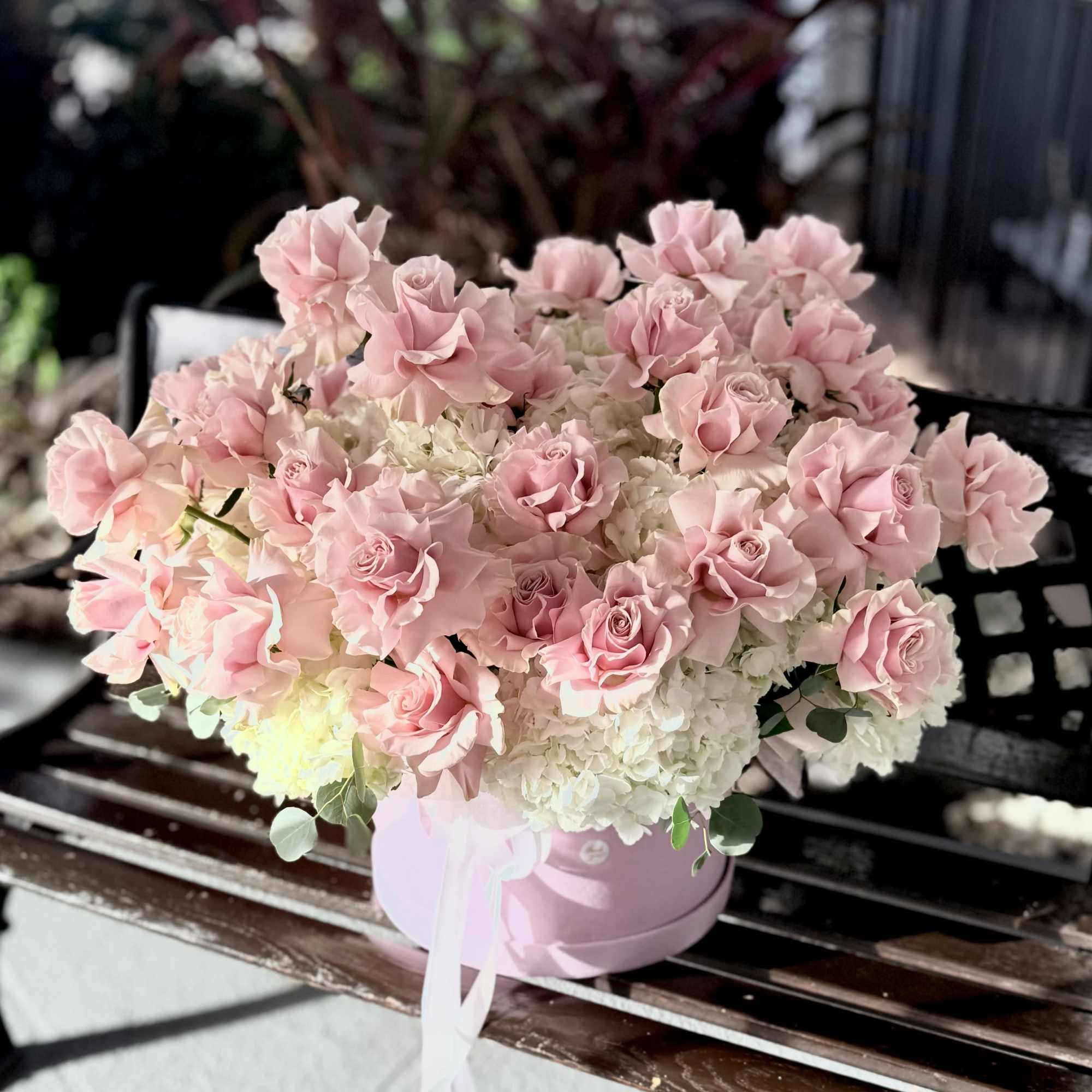 A lush cluster of pale blush roses layered over a cloud of