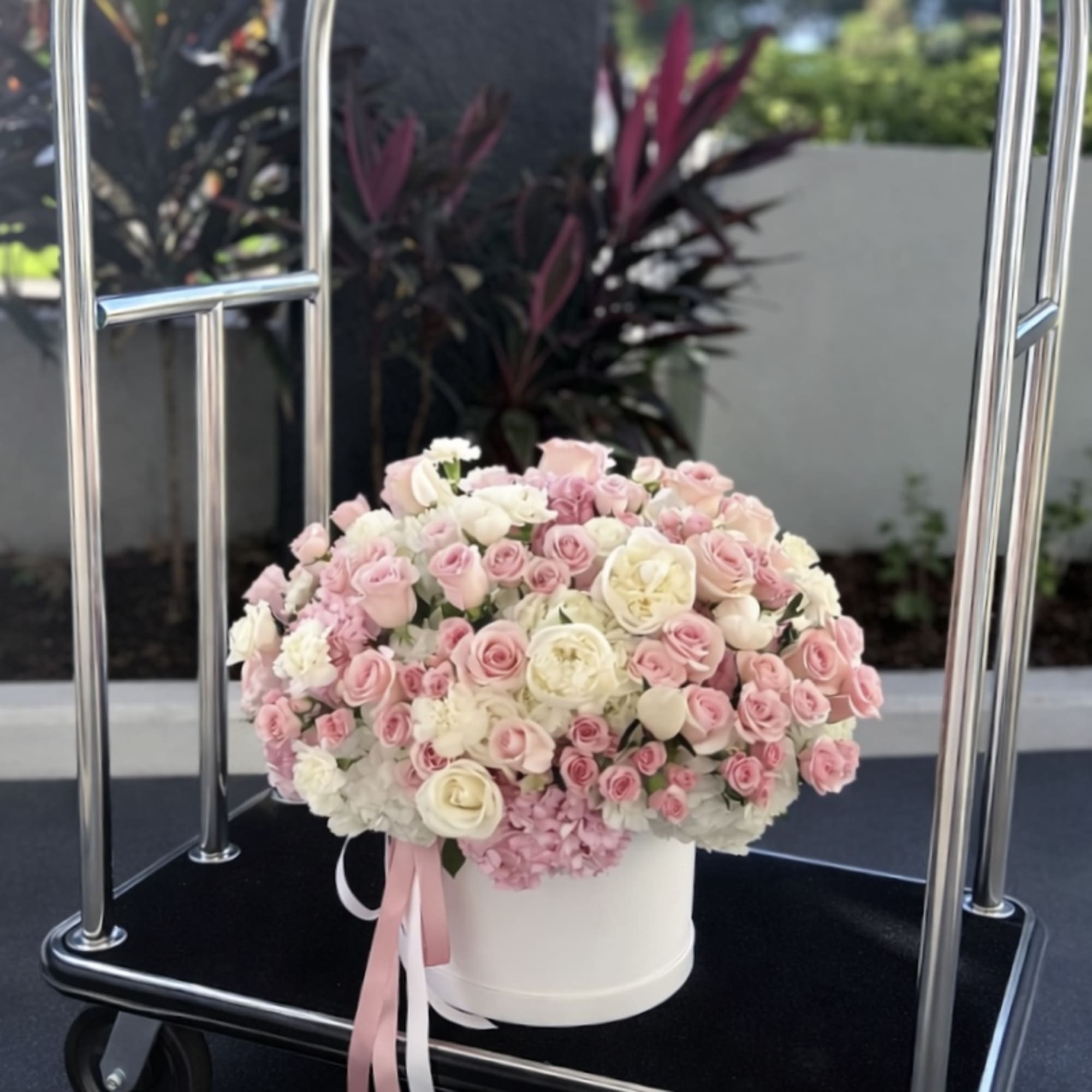 A lush dome of blush pink and ivory roses with soft peach