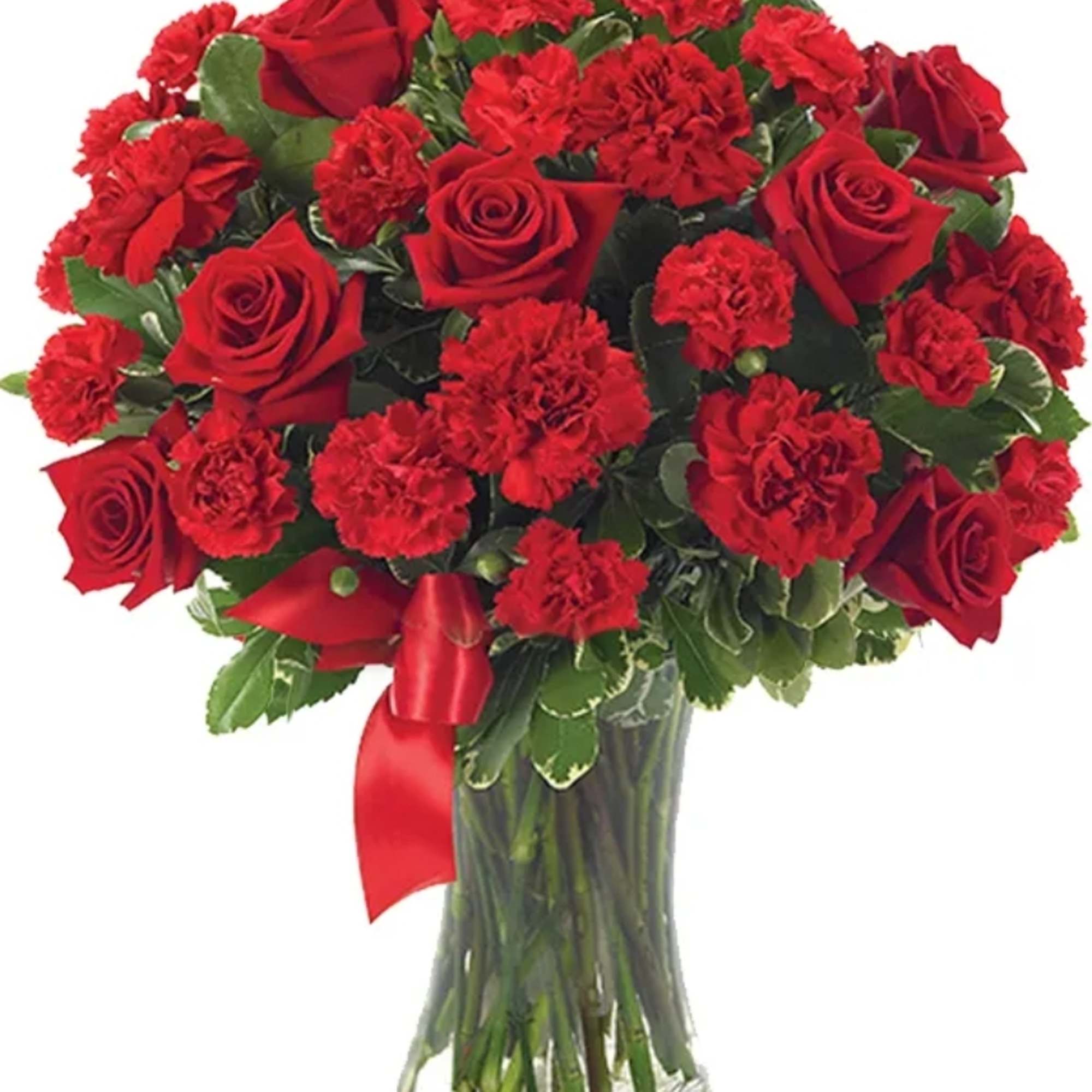 Red roses and carnations in a clear glass vase with a red ribbon