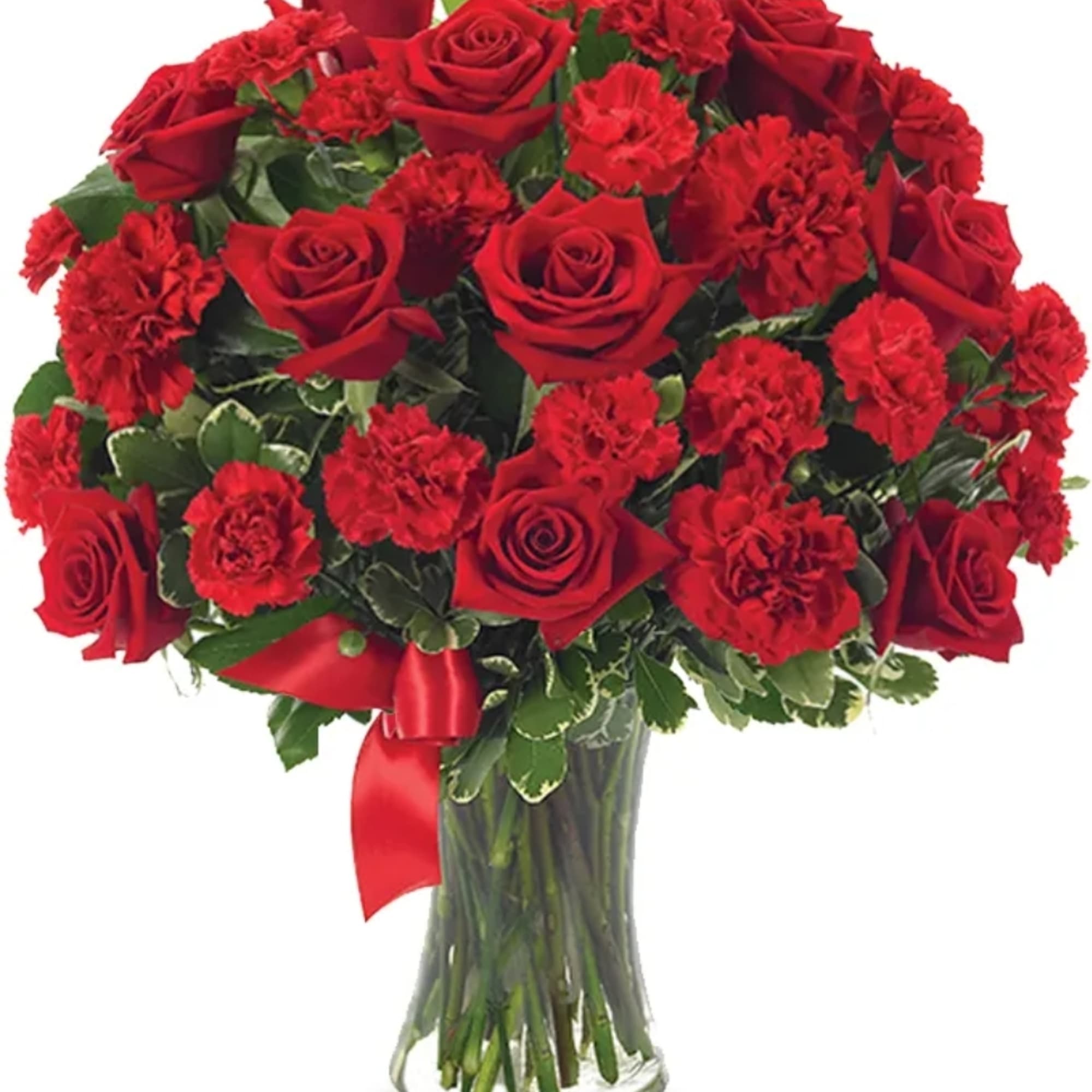 Red roses and carnations in a clear glass vase with a red ribbon