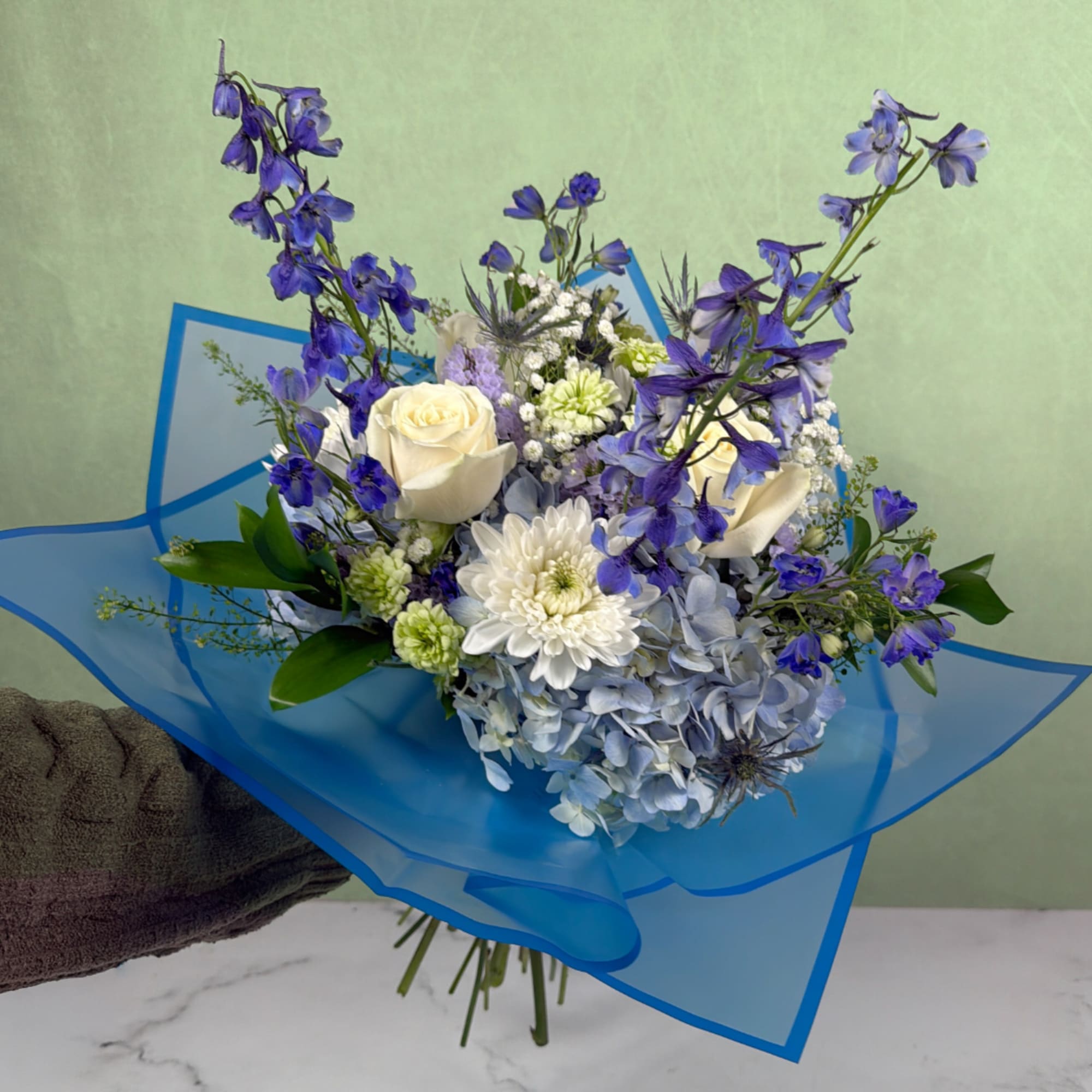 The Whispering Winds Wrapped Bouquet by Savilles Florist is a magnificent display