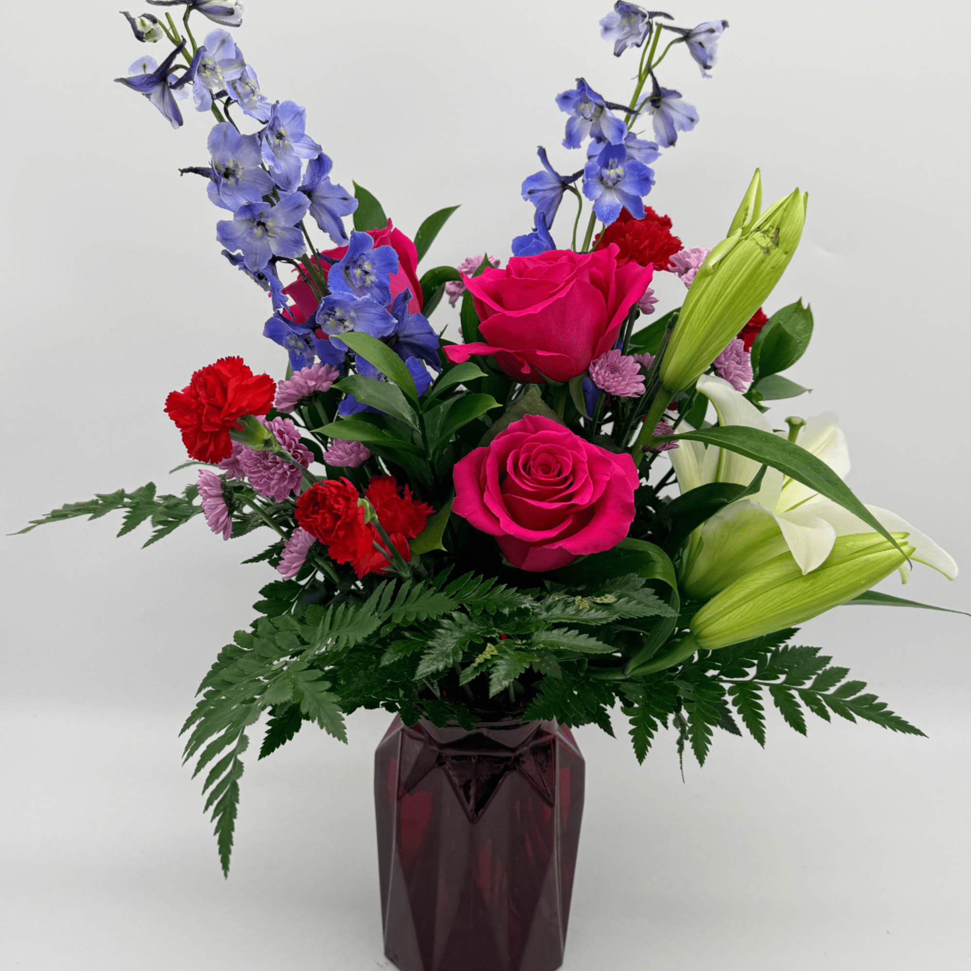 A bright and heartfelt mix of roses, lilies, accent flowers, and fresh