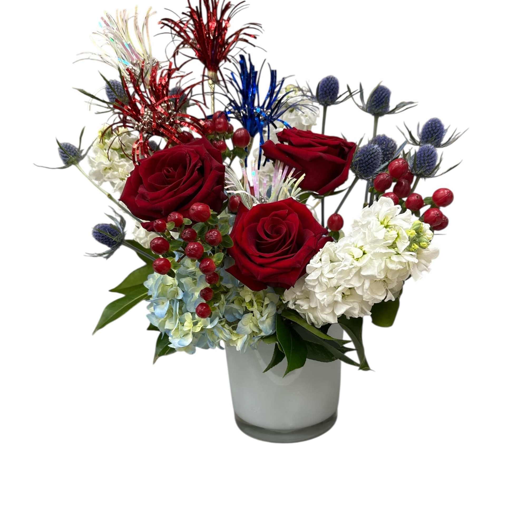 Red roses and white hydrangeas in a glass vase with decorative picks