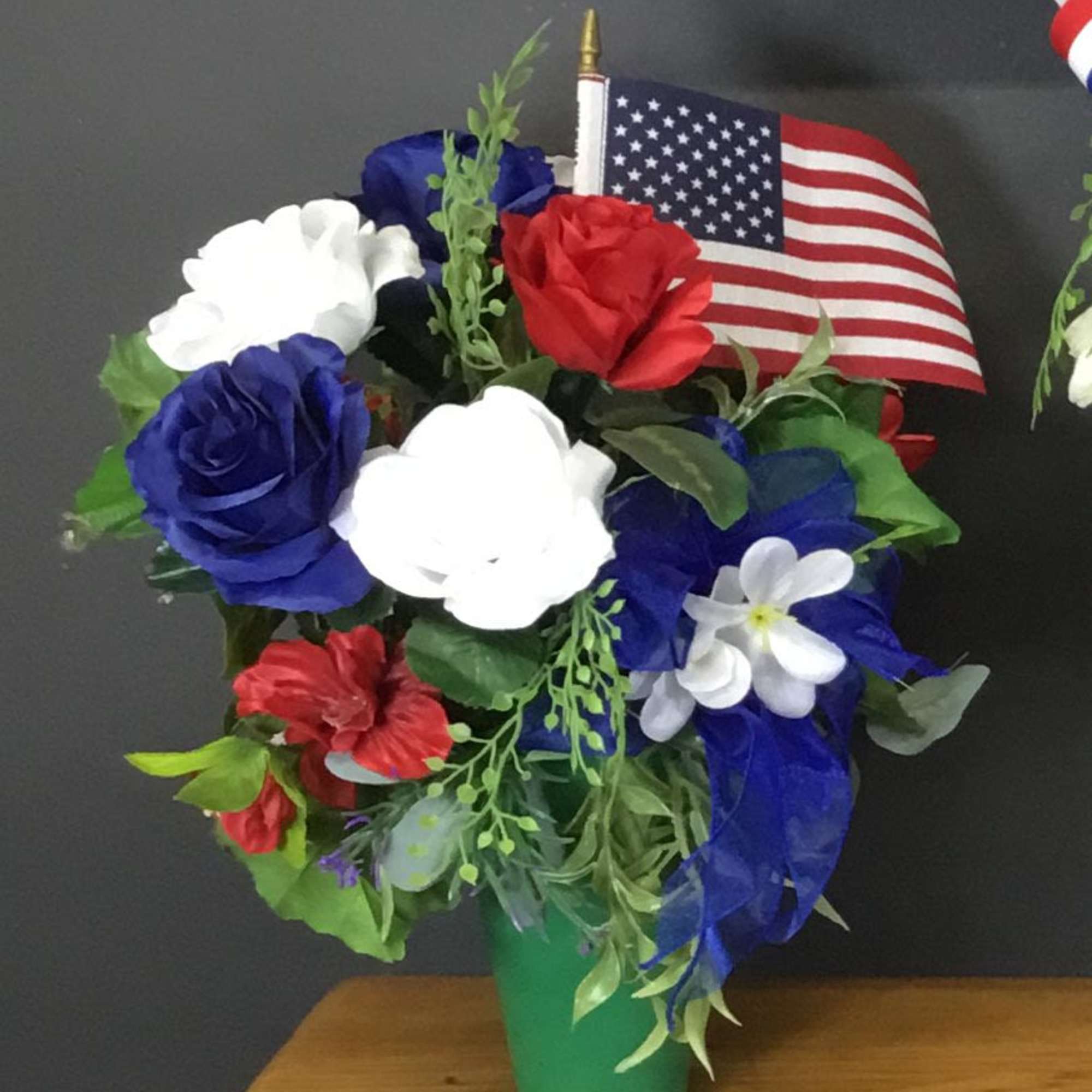 
This artificial arrangement is set in a green cone-style container (green vase)