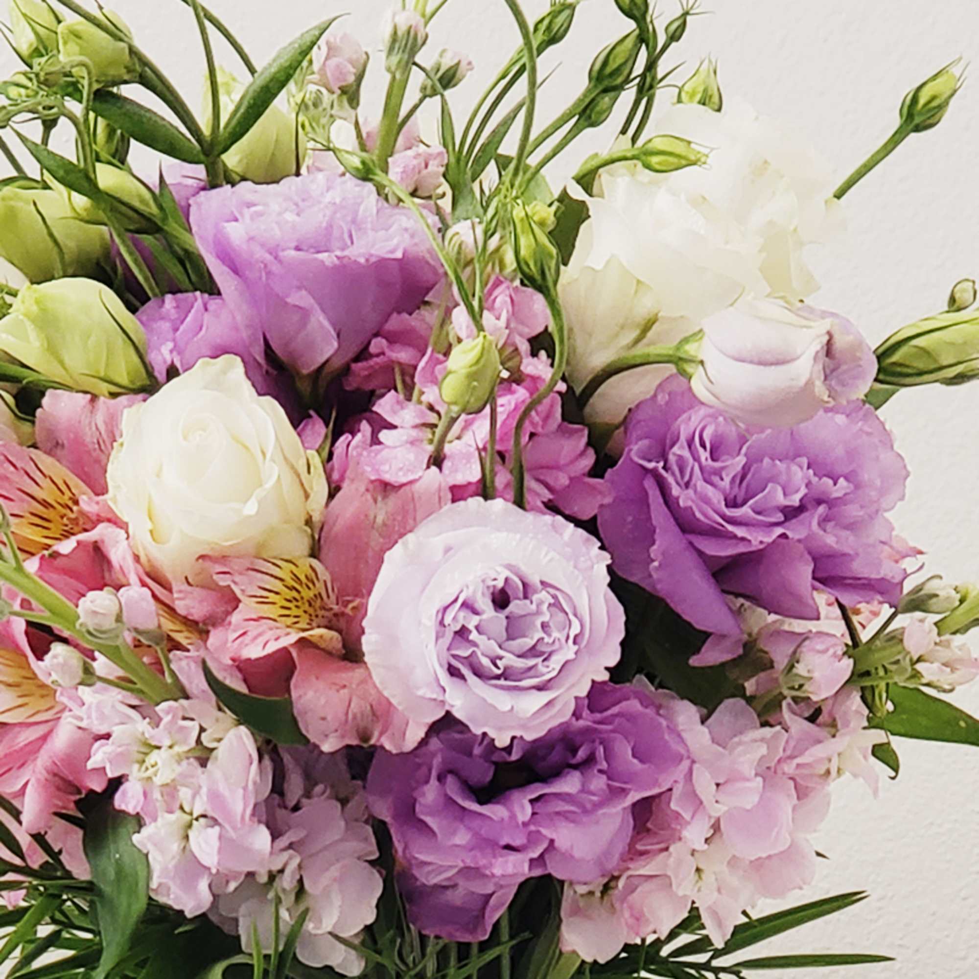 Bouquet of purple, pink, and white flowers with green buds