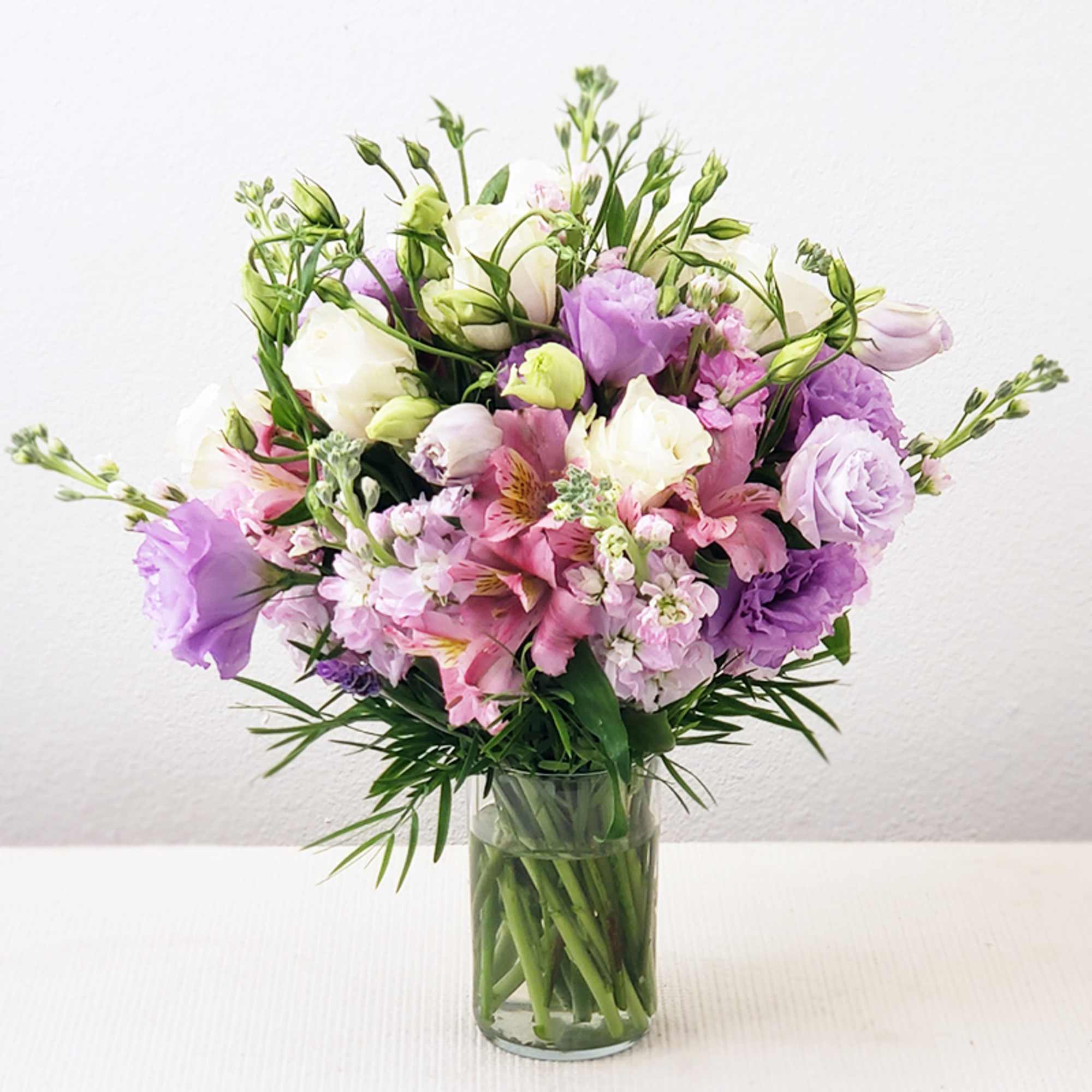 Pink and lavender bouquet in a clear glass vase