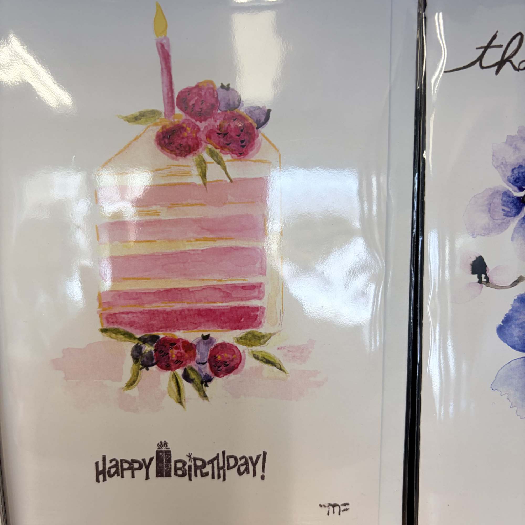 Birthday card with a pink layered cake and floral decorations
