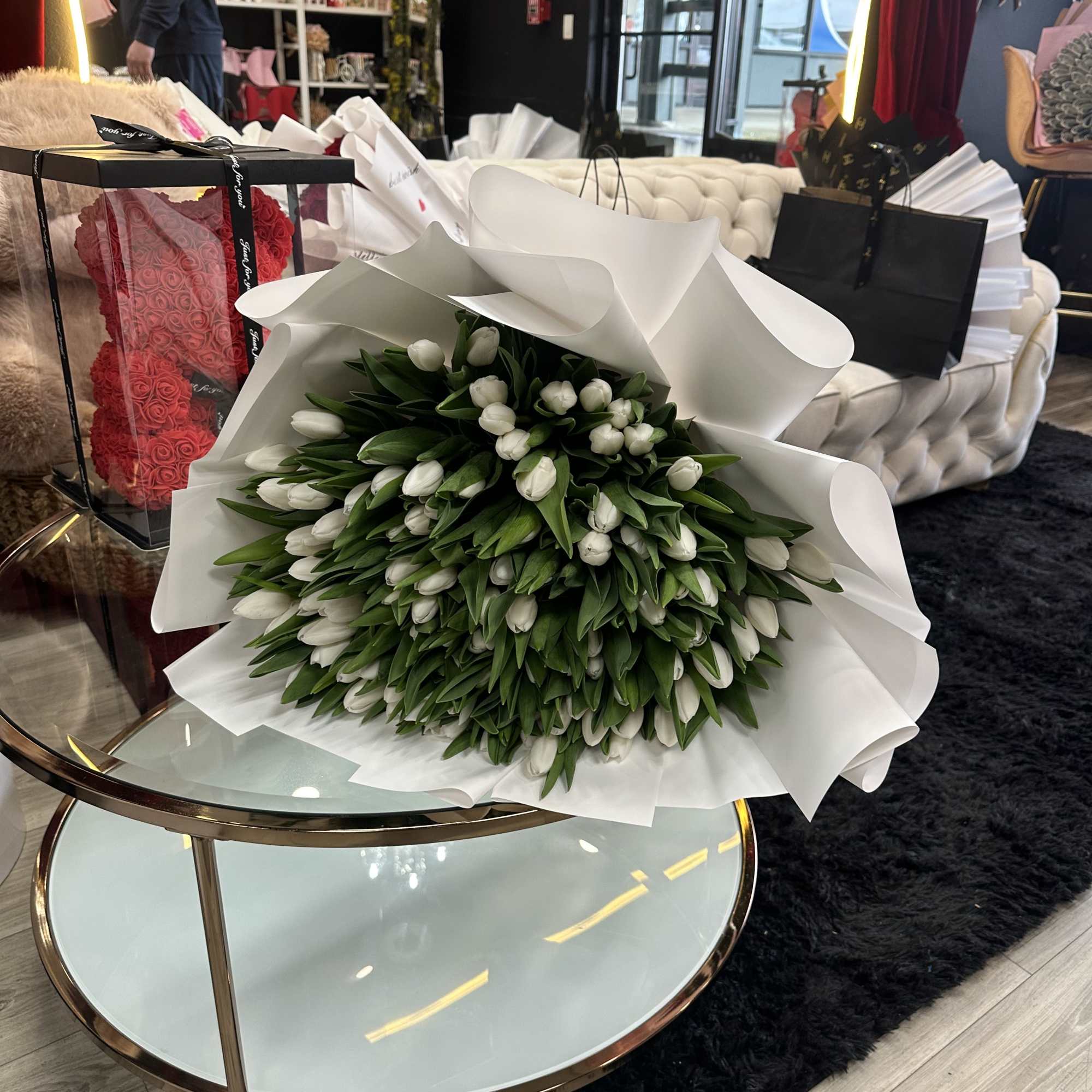This exquisite bouquet features 100 pure white tulips, meticulously arranged to create