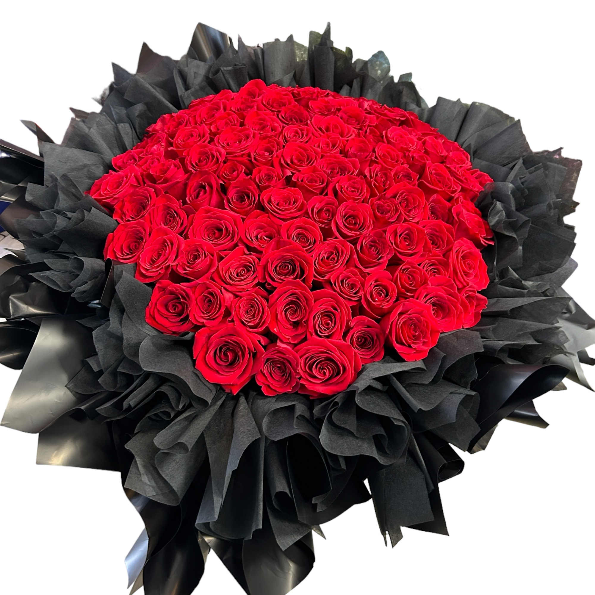 Large bouquet of red roses wrapped in black paper