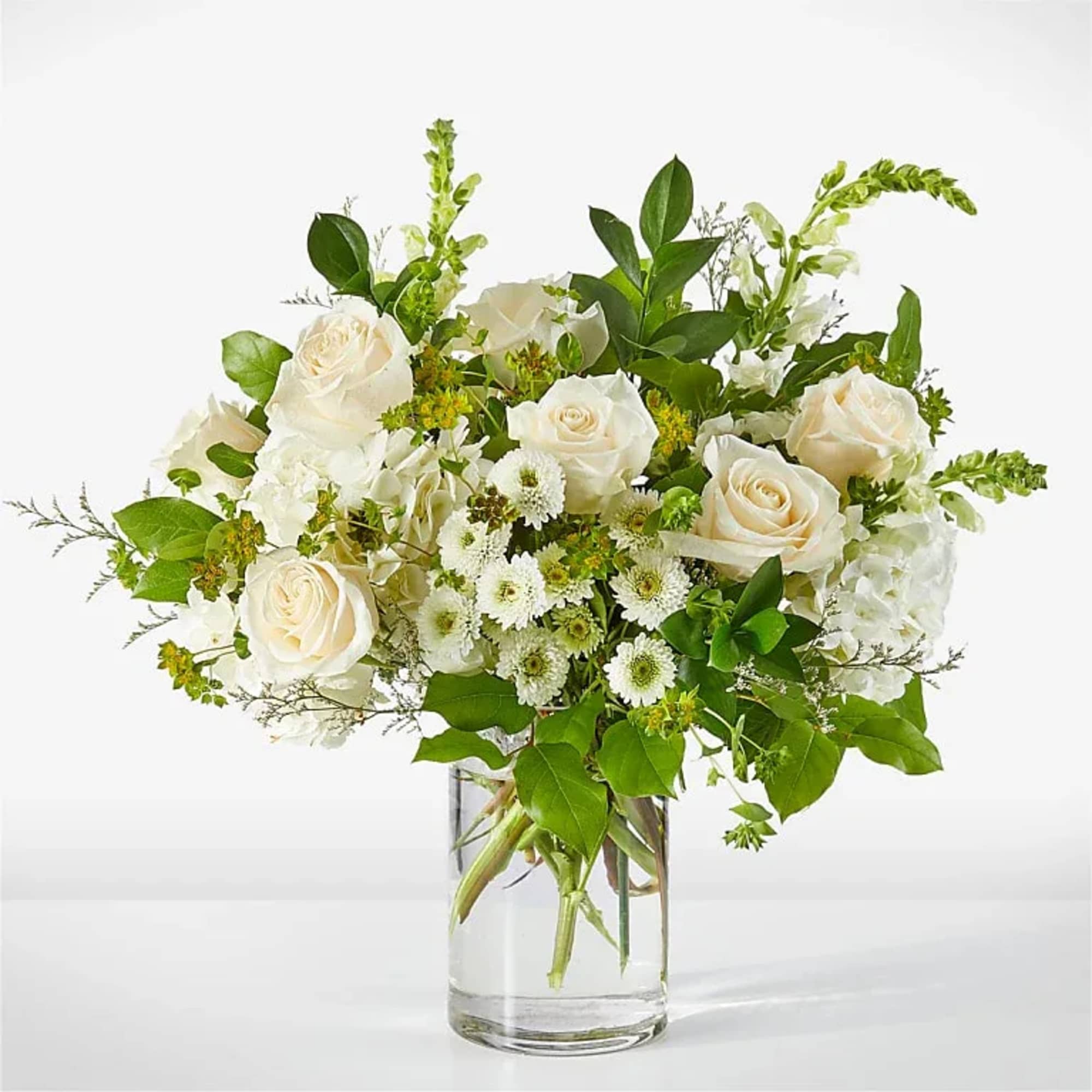 Creamy white roses center the composition of this Hint of Vanilla bouquet