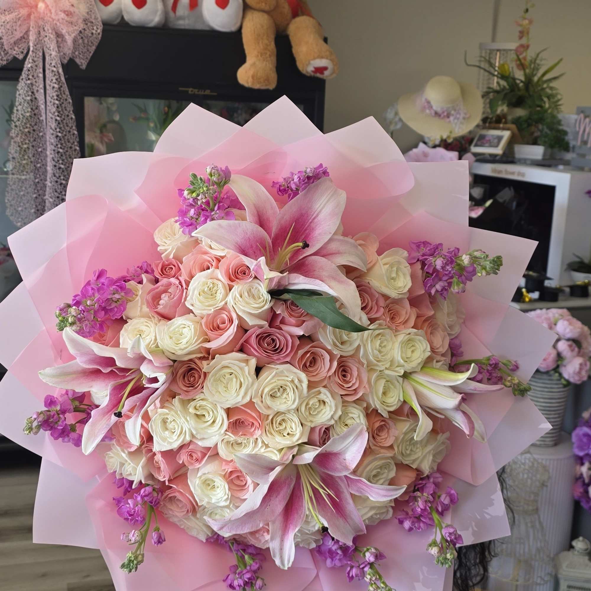 Blush pink and ivory roses mingle with open pink-and-white lilies in this