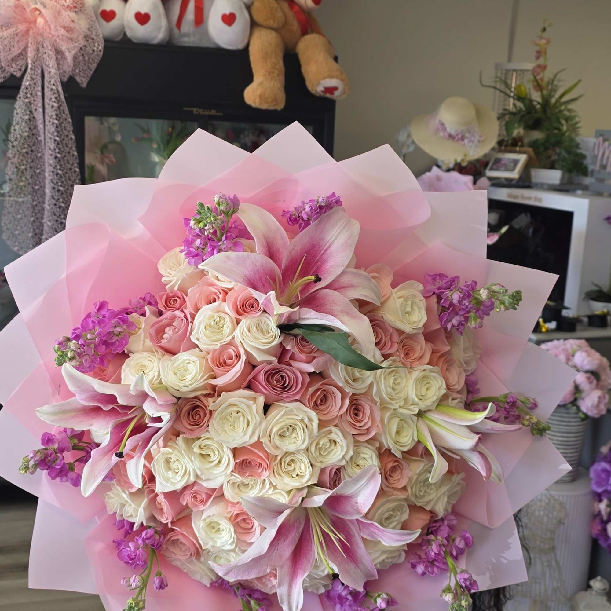 Blush pink and ivory roses mingle with open pink-and-white lilies in this