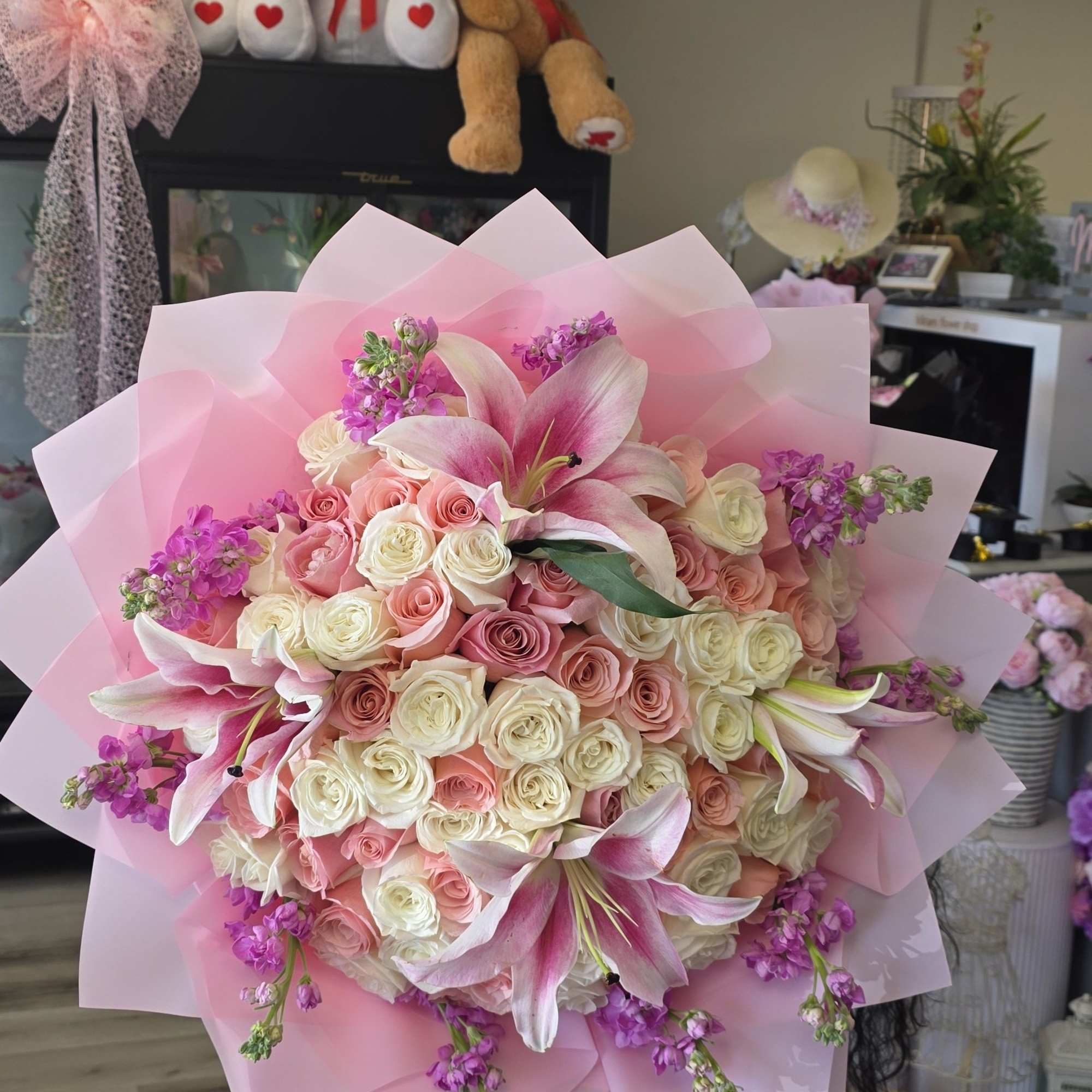 Blush pink and ivory roses mingle with open pink-and-white lilies in this
