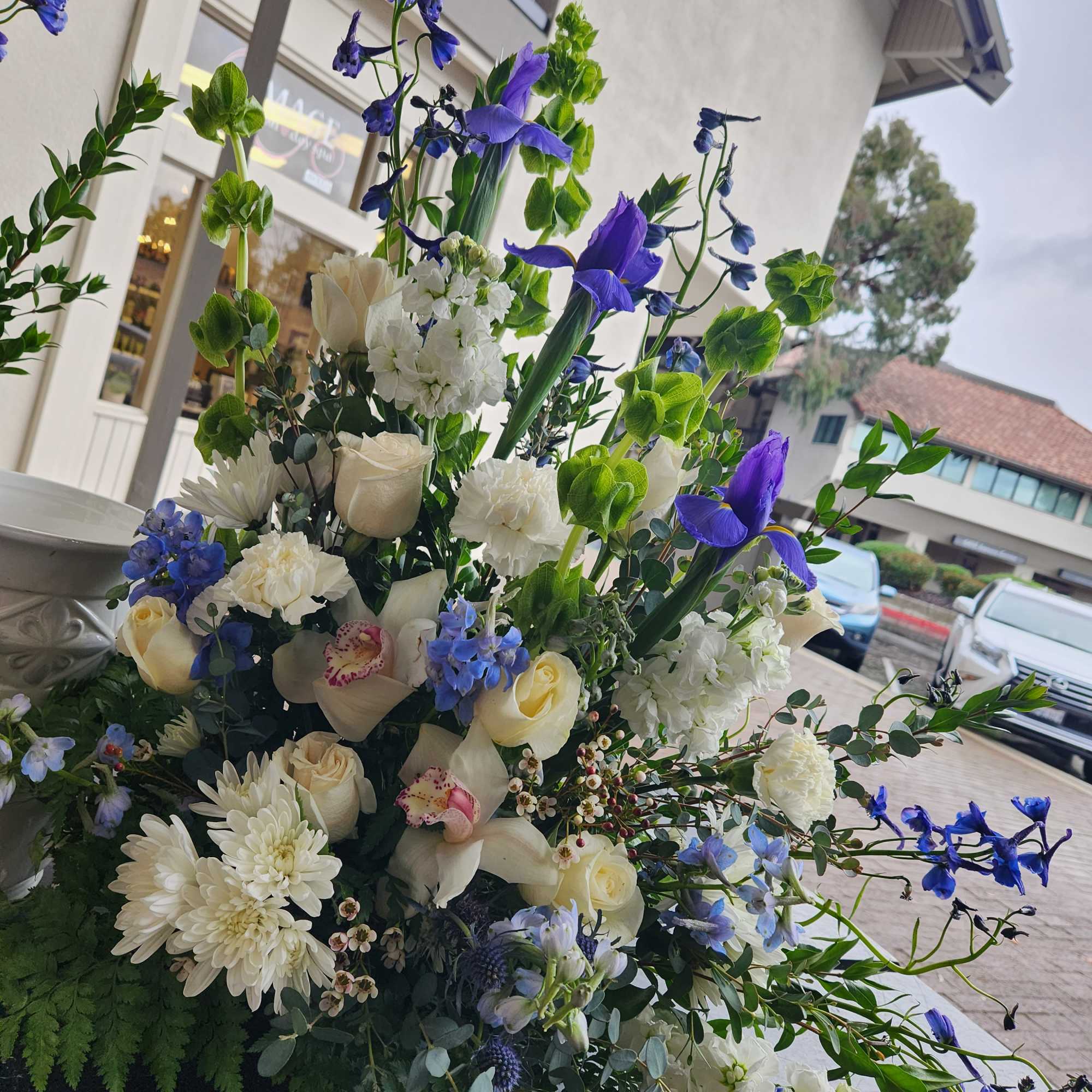 Large bouquet of white and blue flowers with tall stems
