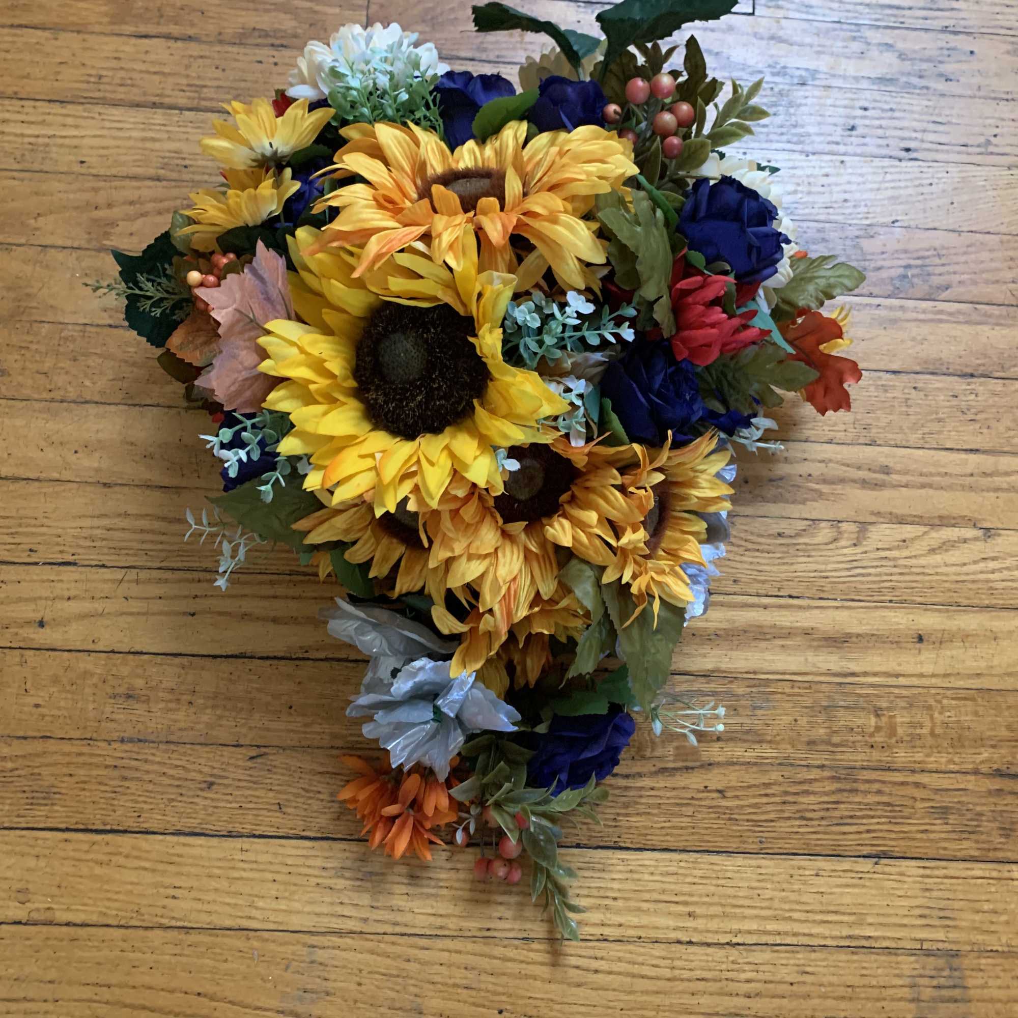 Bright, bold sunflowers take center stage in this sunflower bridal bouquet, a