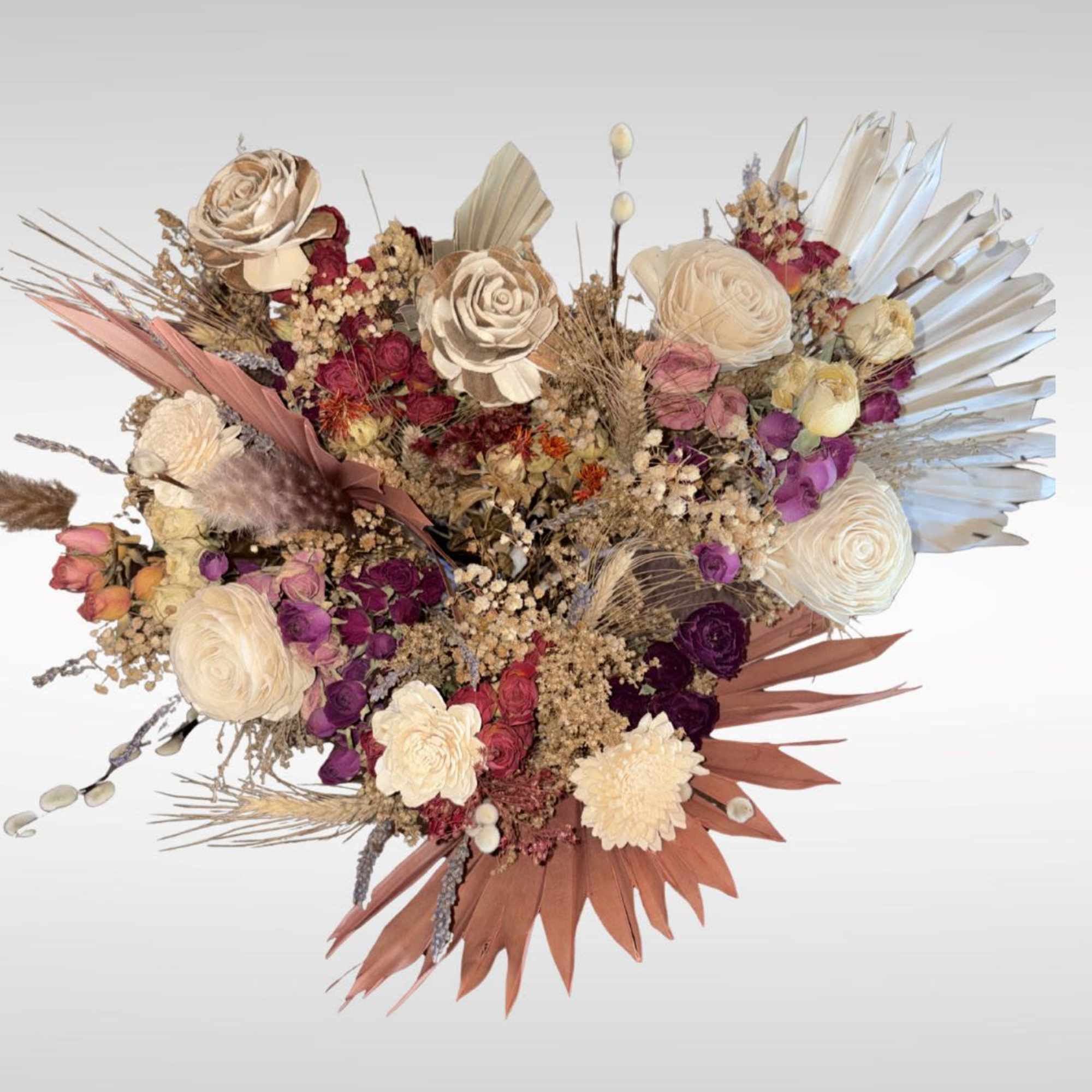 These dried flower bouquets include a dried leaf fan, wheat, babies breath