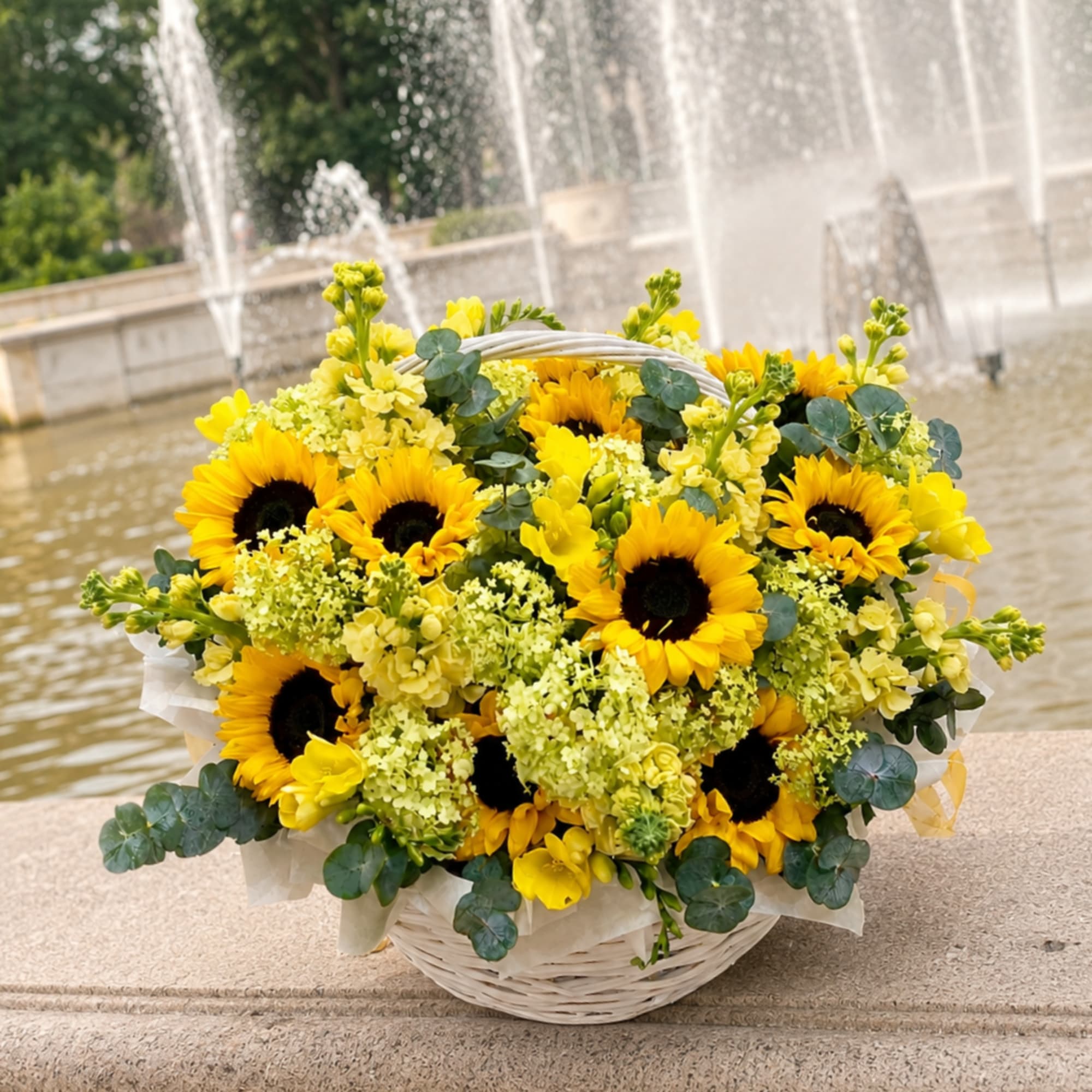 Bright, cheerful sunflowers take center stage in this casual sunflower arrangement for