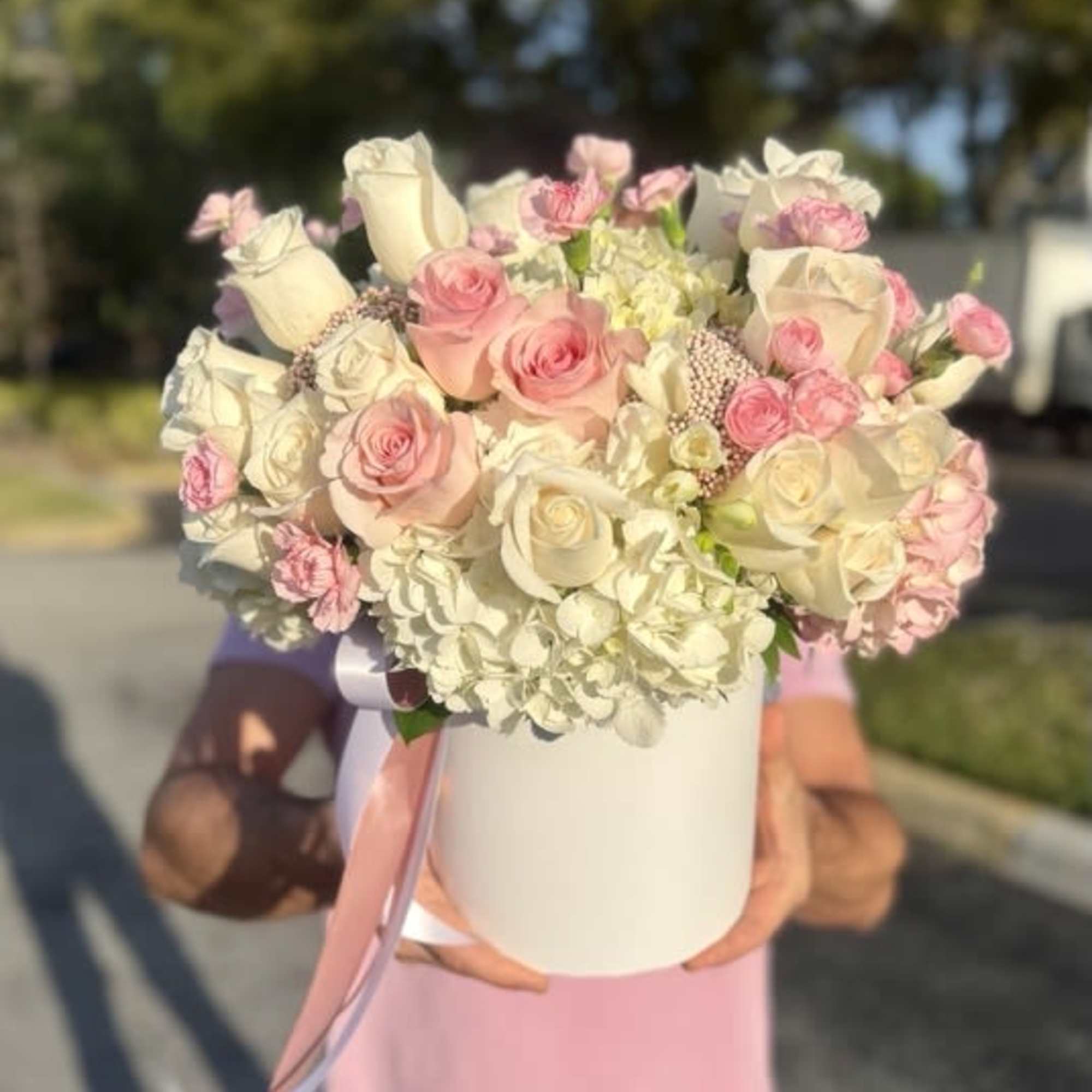 Soft blush and ivory roses gathered with clouds of white hydrangea create