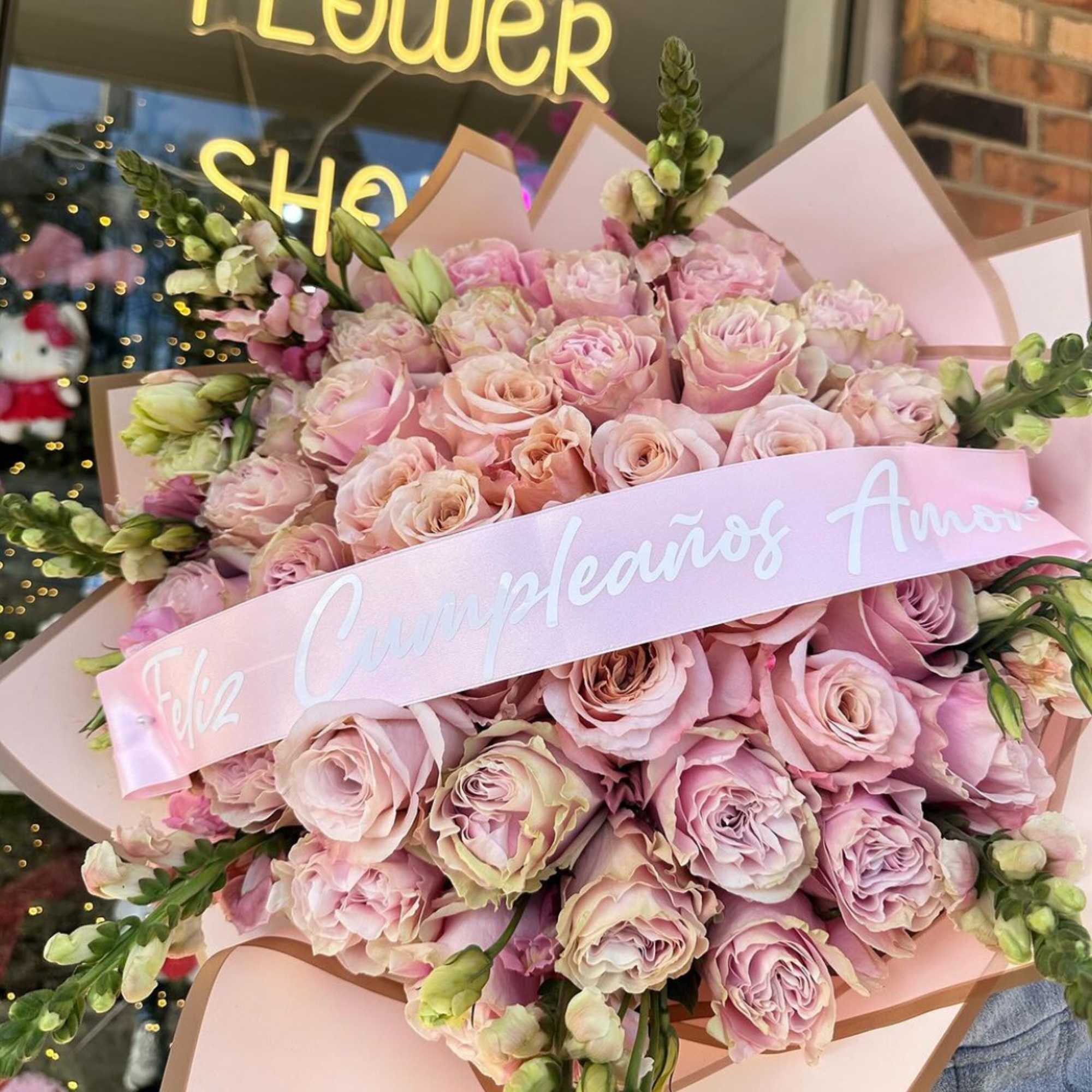 Large bouquet of pale pink roses with a pink ribbon