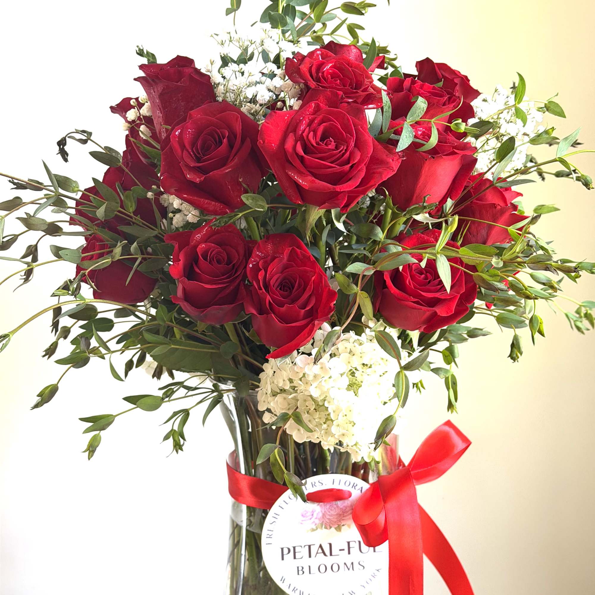 Beautiful long stemmed red roses with seasonal fillers. Perfect romantic gift for