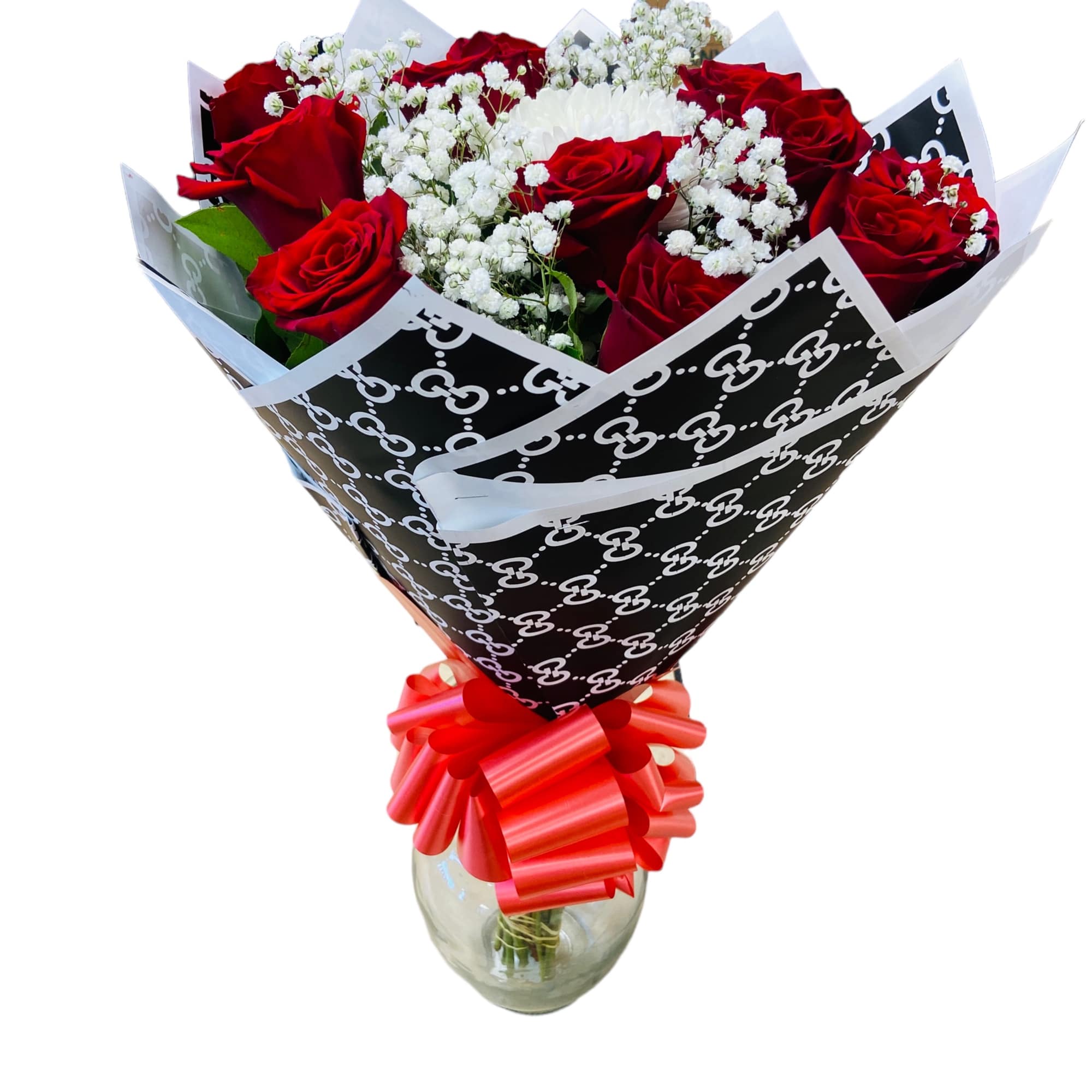 Bouquet of red roses and white baby's breath in a glass vase