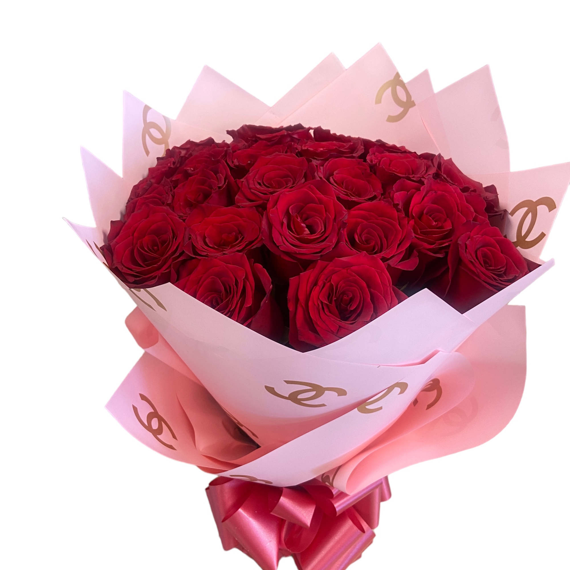 Bouquet of red roses wrapped in pink paper with a ribbon