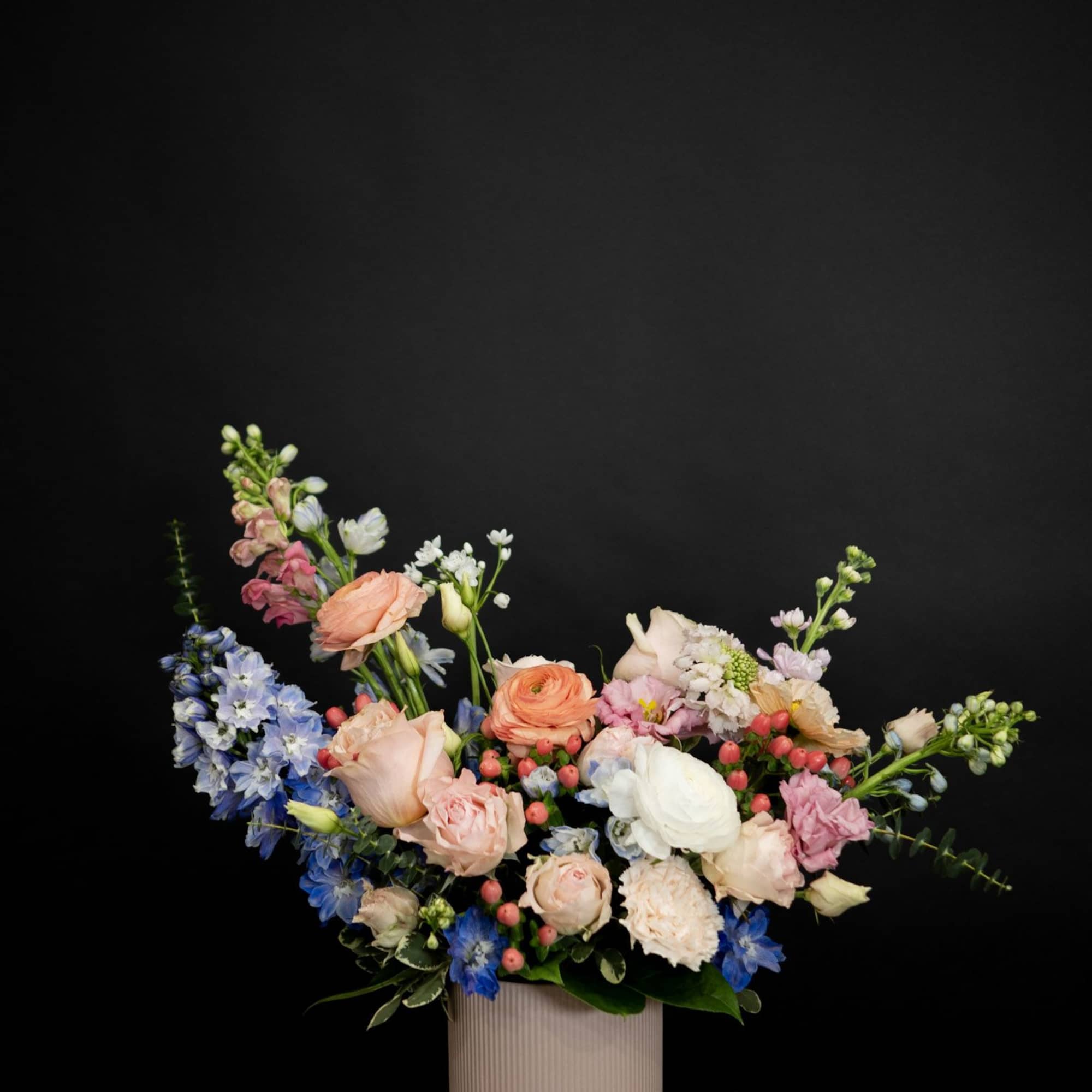 Mixed pastel bouquet in a ribbed pink vase