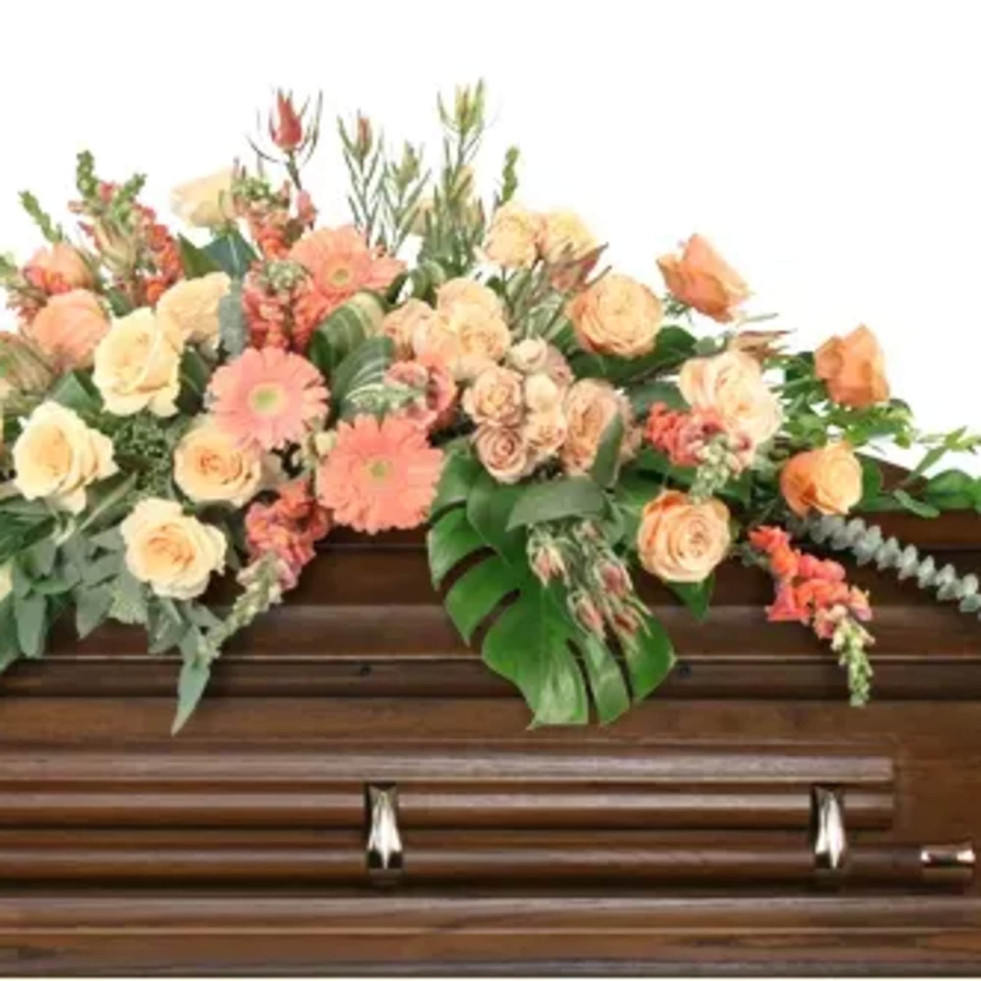 In a symphony of warmth and grace, this casket spray captivates with