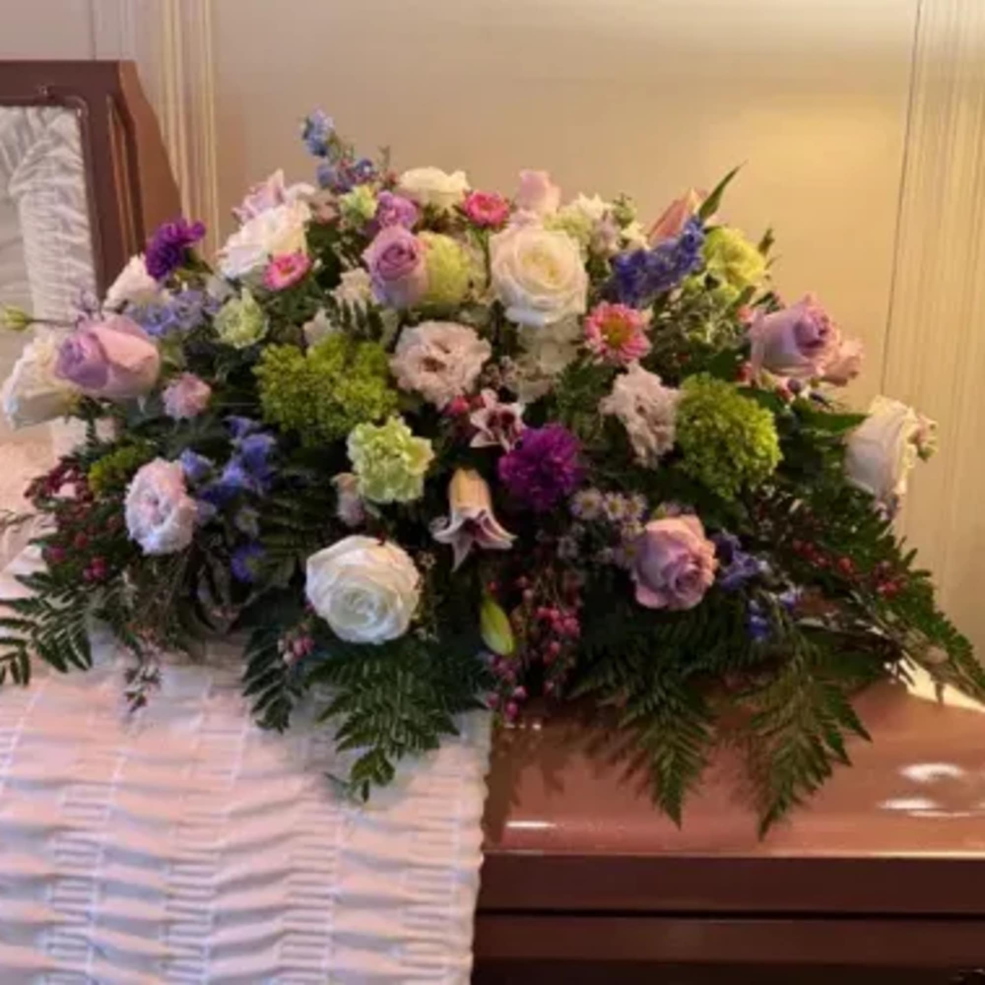 Beautiful lavenders,pink lilies, green hydrangeas and white roses designed for the casket
