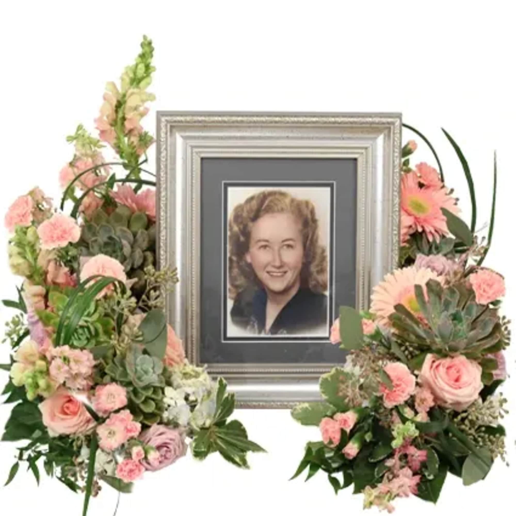 Touching Tranquility exudes serene remembrance with succulents, pink larkspur, lavender and pink