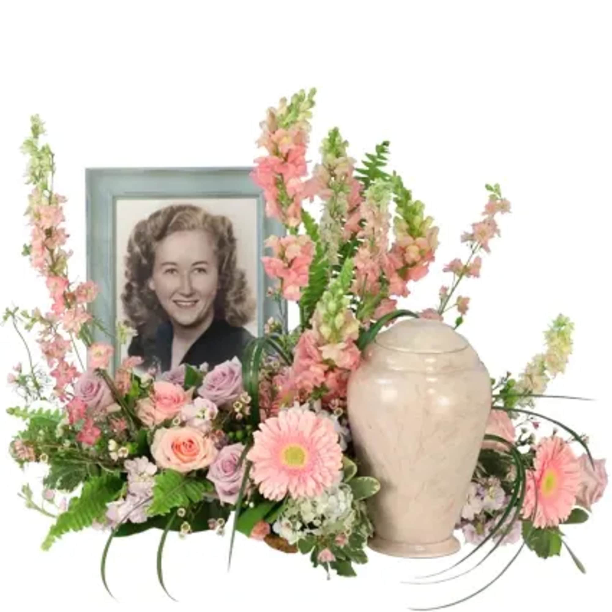This heartfelt memorial arrangement is adorned with pink, lavender, and blue hues