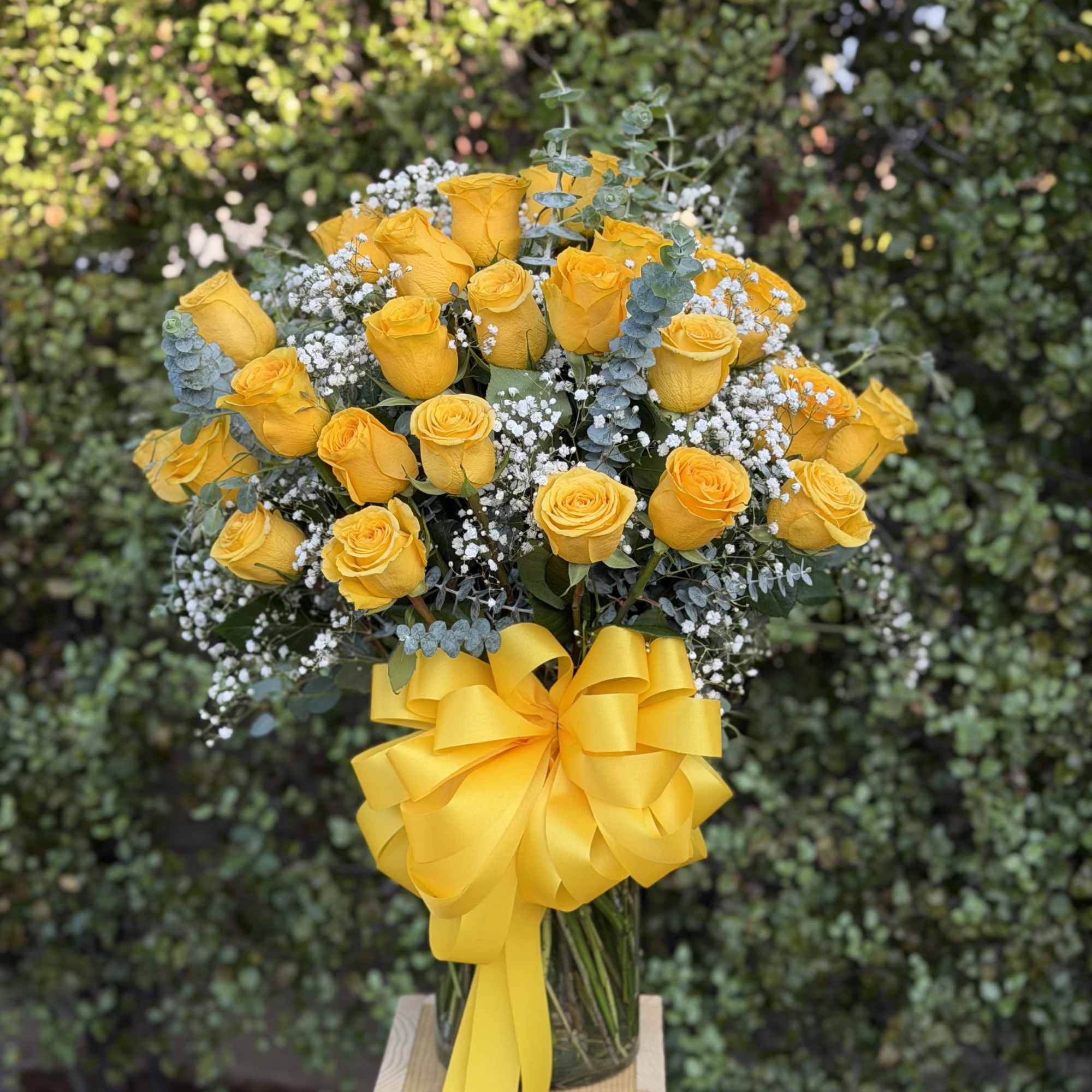 A dense cloud of three dozen bright yellow roses creates an immediate