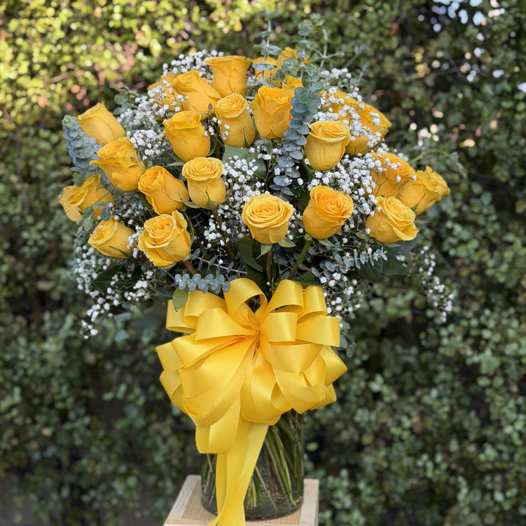 A dense cloud of three dozen bright yellow roses creates an immediate