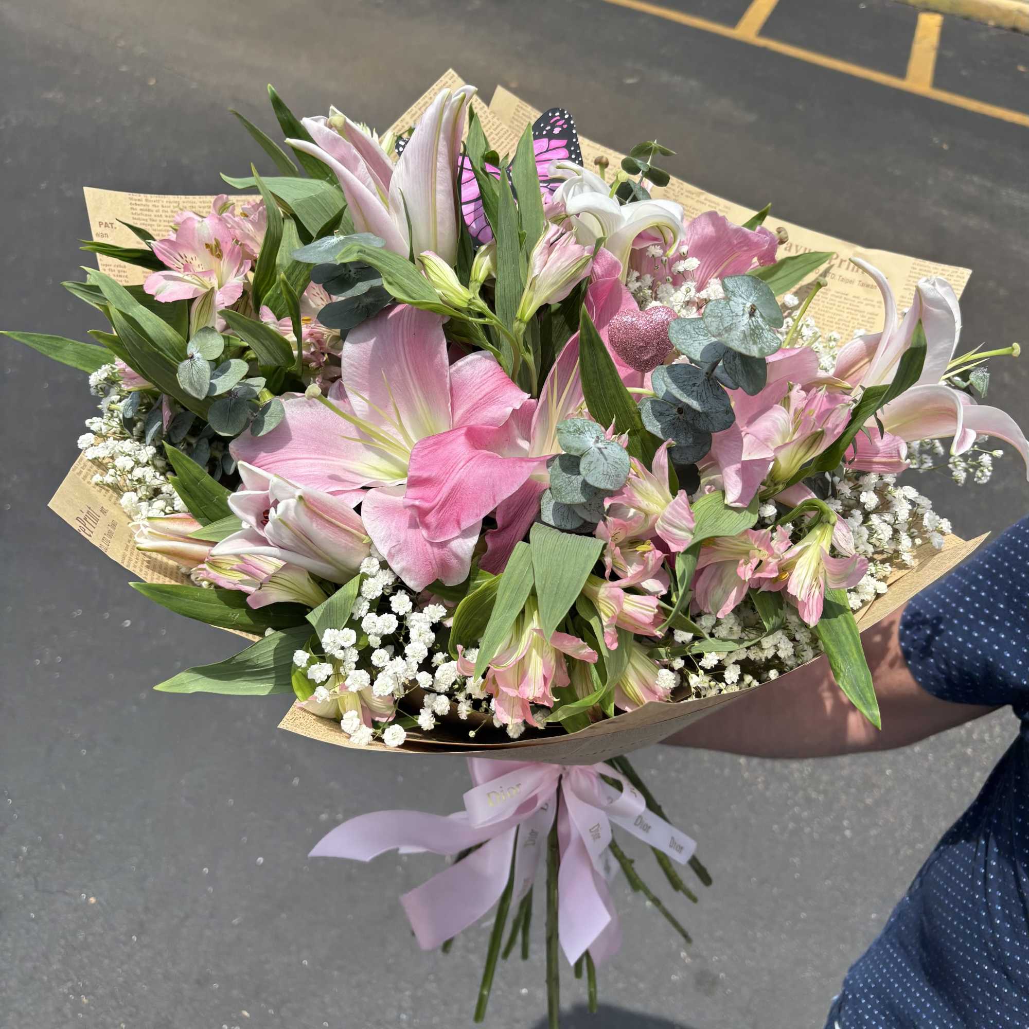 Large pink and white lilies mingle with delicate pink alstroemeria and cloud-like