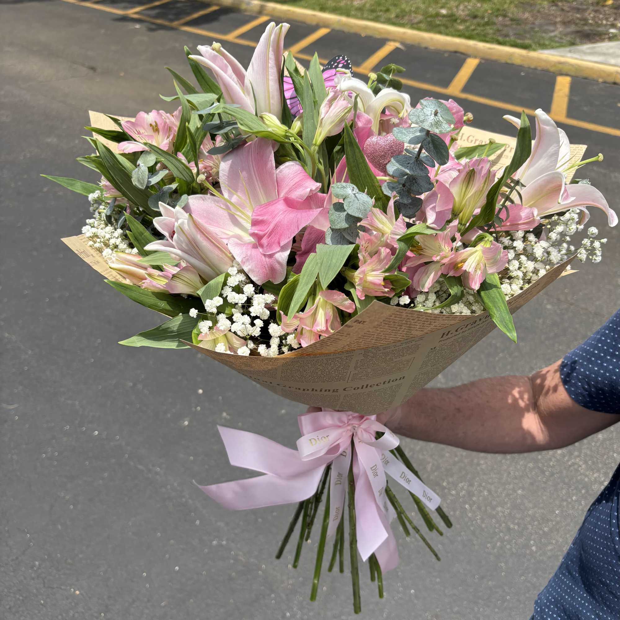 Large pink and white lilies mingle with delicate pink alstroemeria and cloud-like