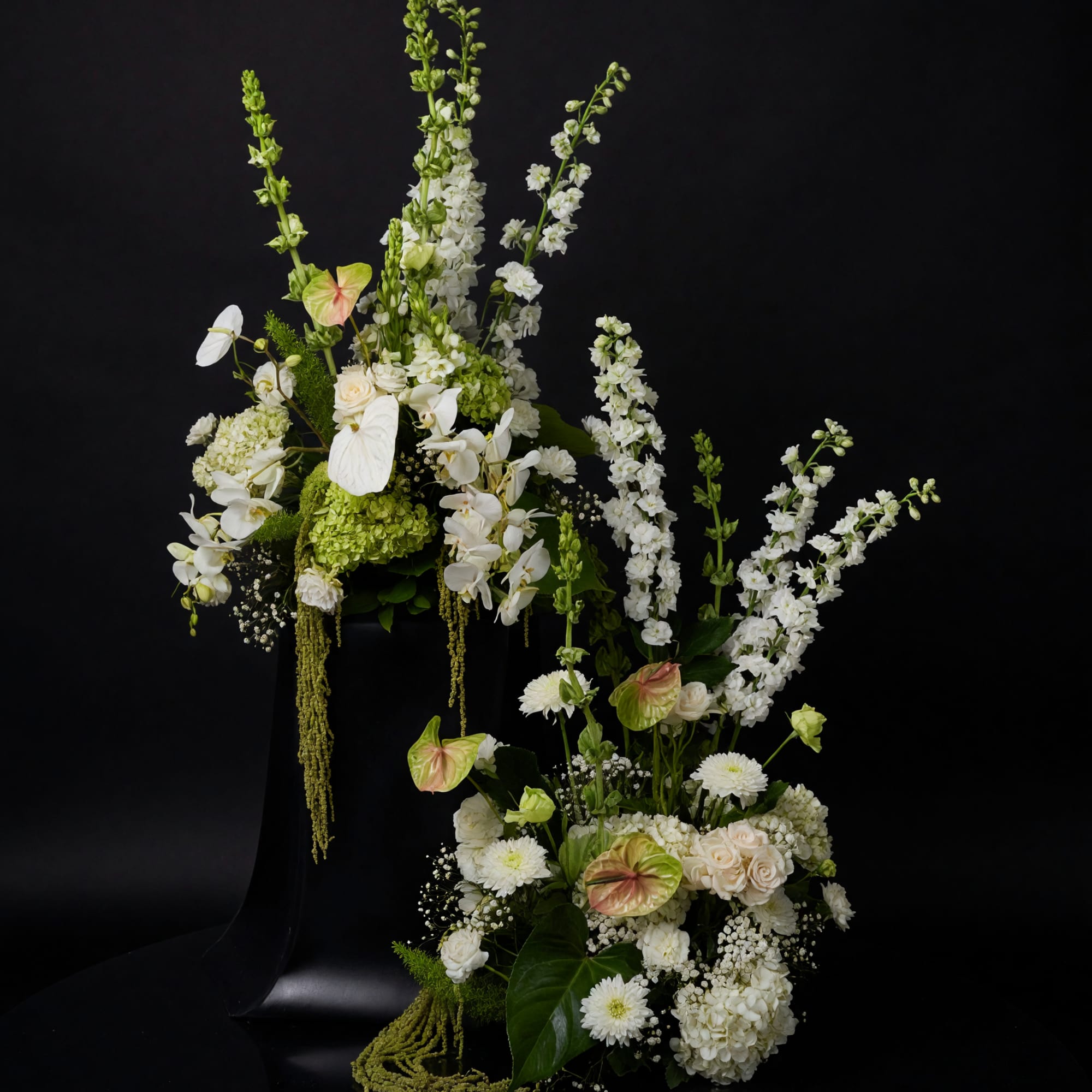 A refined ceremony installation of sculptural white floral compositions designed to bring
